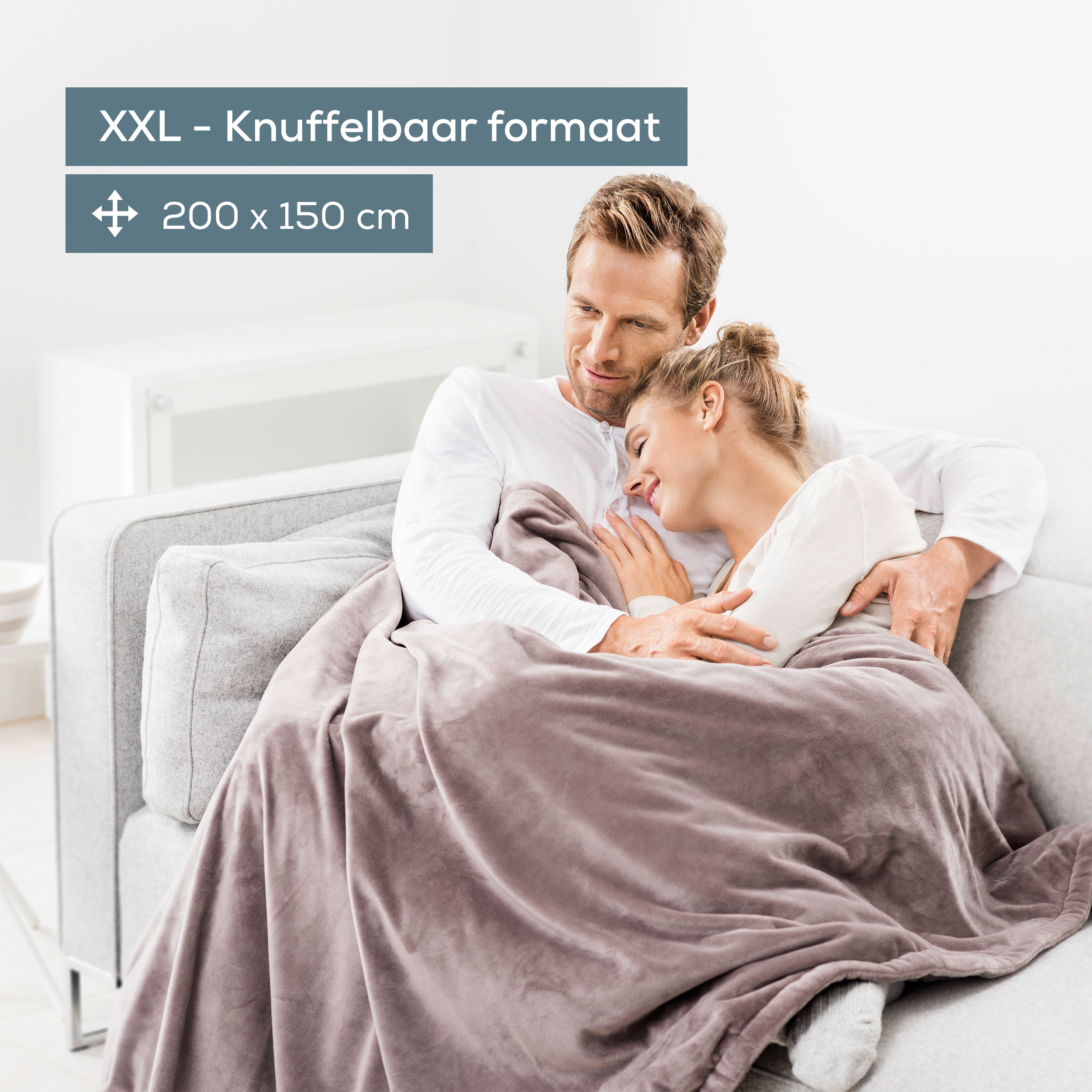 A couple on a couch, covered by a blanket. Dimensions are 200x150cm.