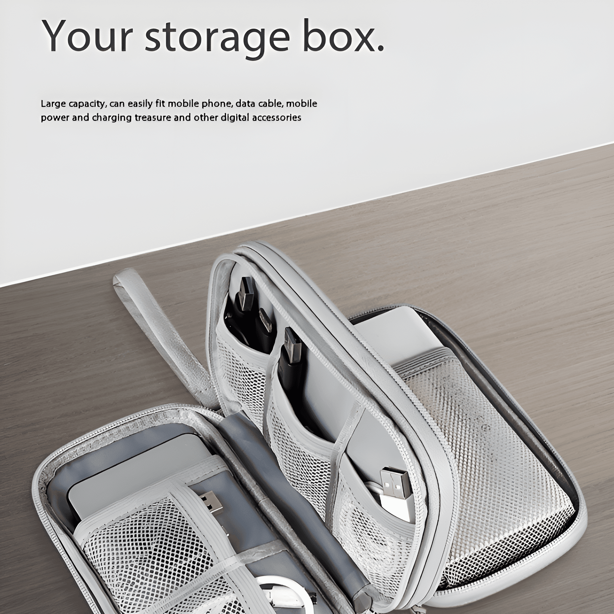 Offene Aufbewahrungsbox mit Fächern. Enthält Kabel, ein Telefon und ein Ladegerät.