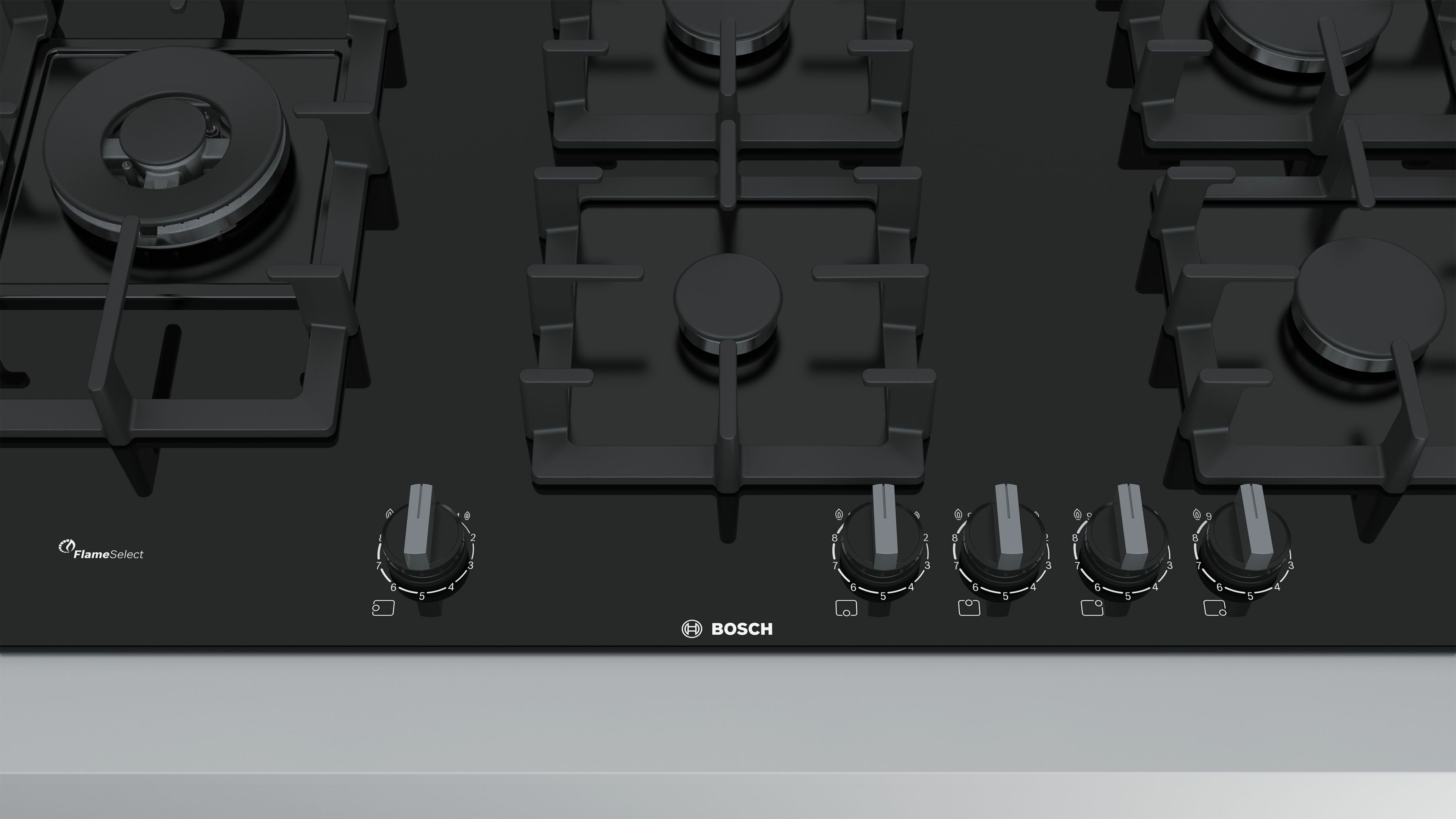 Black gas hob with 5 burners. Top view, with knobs and Bosch logo.