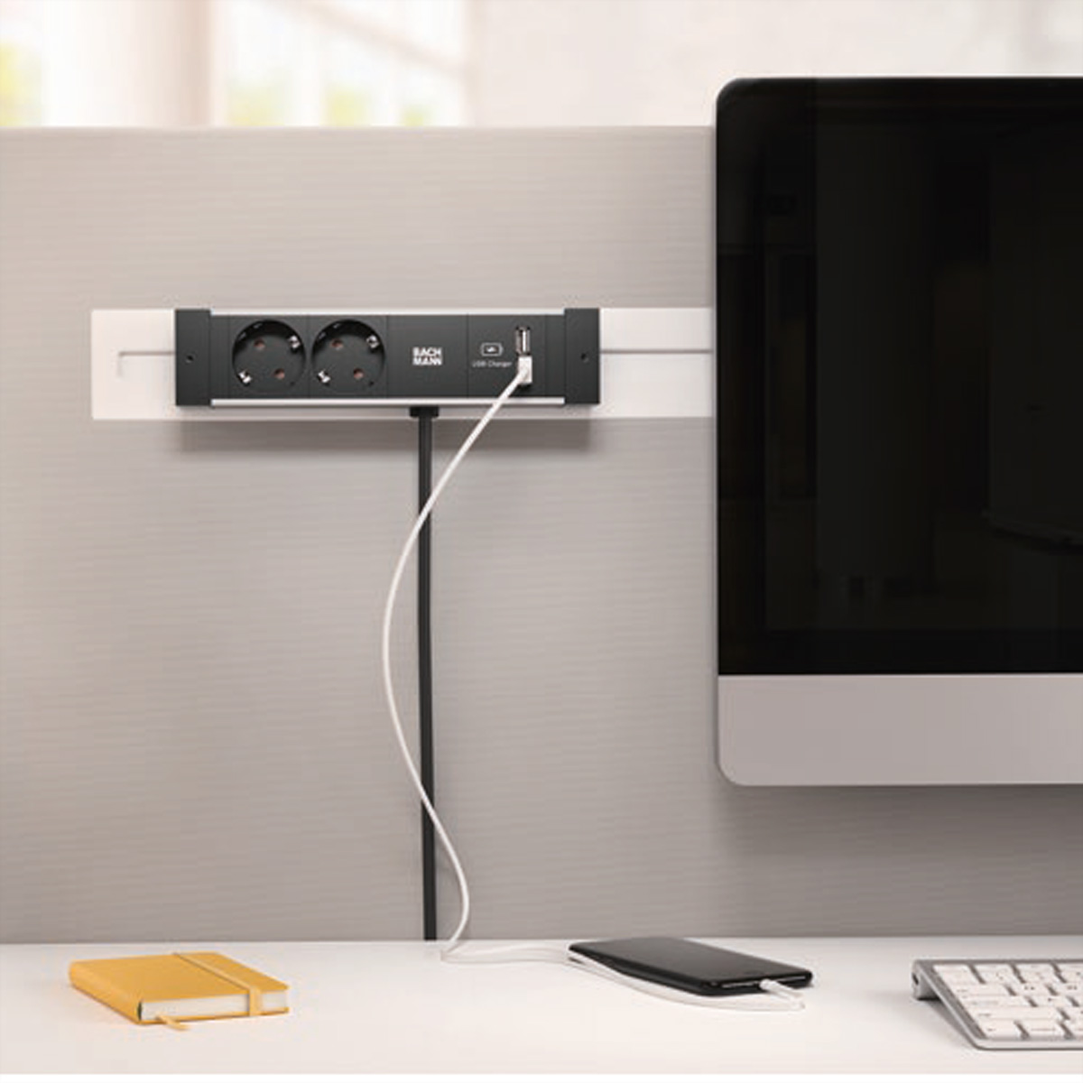 Una ciabatta montata a parete, con due prese, un caricatore USB e un cavo collegato.
