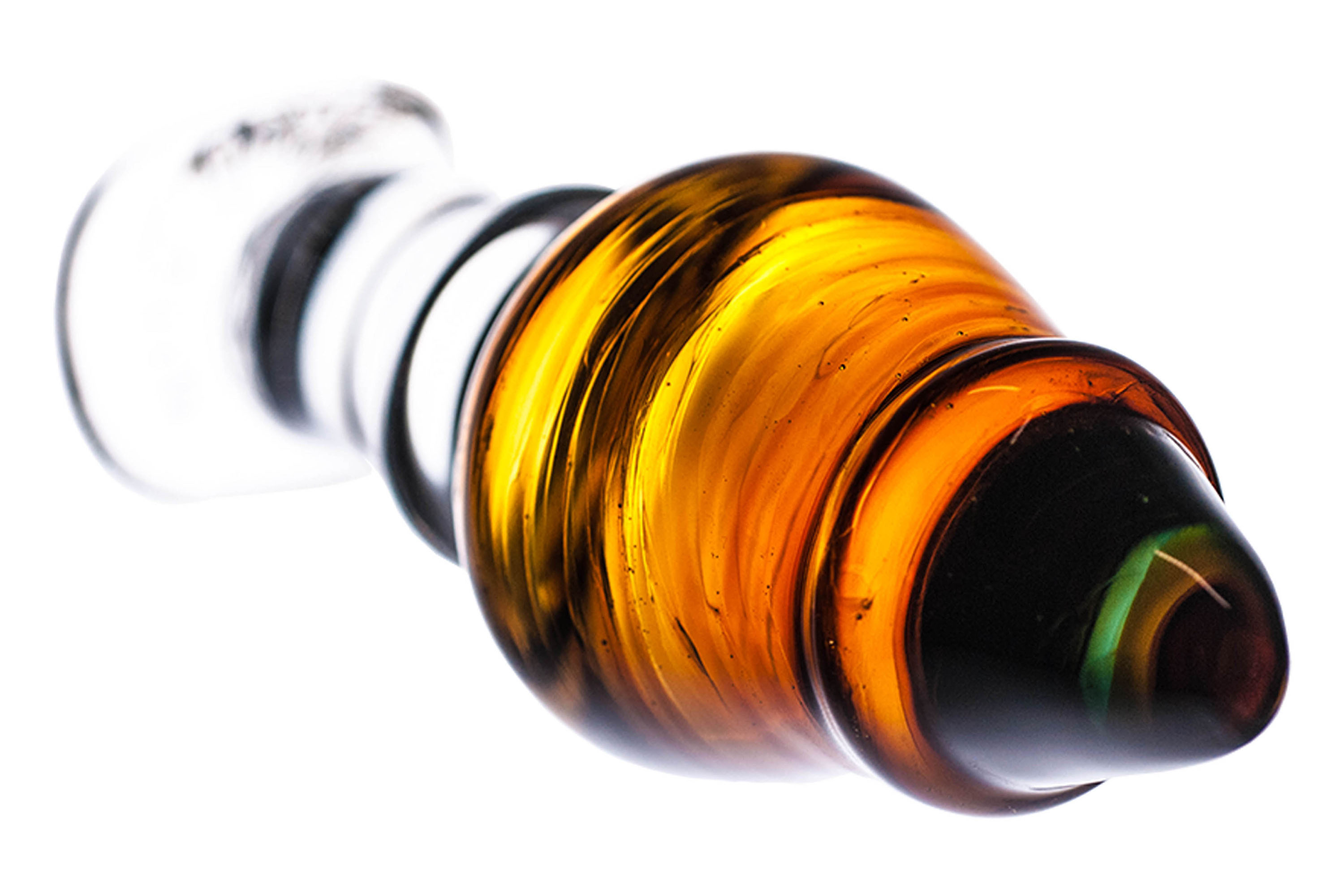 Glas-Buttplug, klarer Griff, bernsteinfarbener Körper, schwarze Spitze. Weißer Hintergrund.