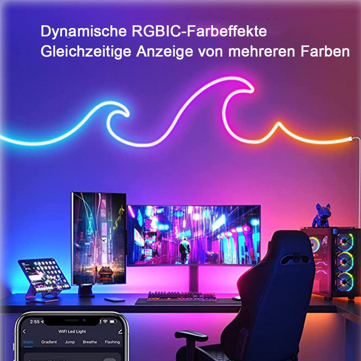 Ein Schreibtisch mit Monitor und Computer, beleuchtet von bunten LED-Lichtern in Wellen.