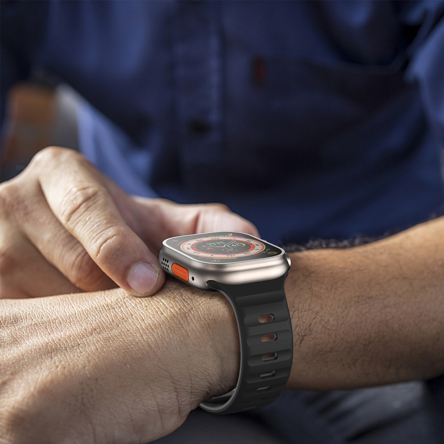 Nahaufnahme eines Handgelenks mit einer Smartwatch. Die Uhr ist silber und schwarz mit einem schwarzen Armband.