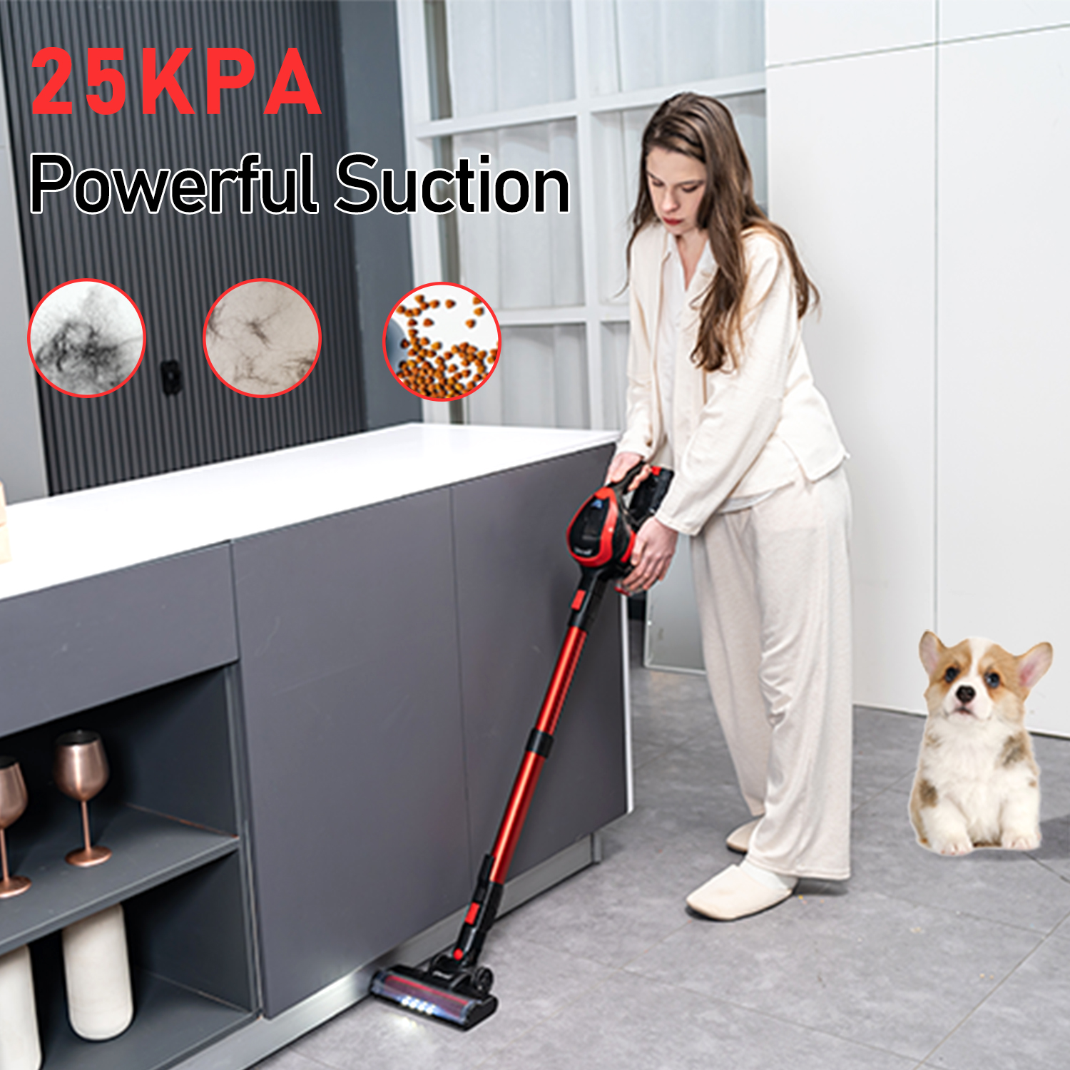 Kobieta odkurza podłogę w kuchni czerwonym odkurzaczem. W pobliżu pies corgi.