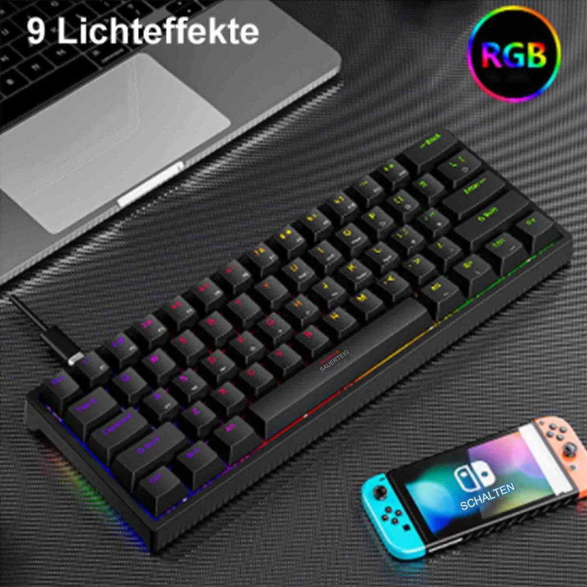 Kleine schwarze Tastatur mit bunten Tasten. Ein Laptop und eine Spielkonsole sind ebenfalls sichtbar.