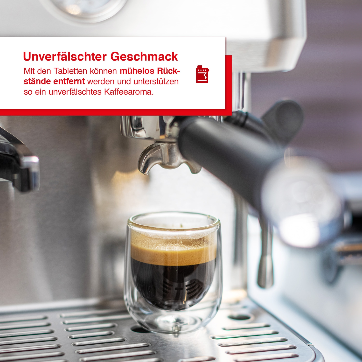 Espressomaschine mit doppelwandigem Glasbecher gefüllt mit Kaffee. Text ist sichtbar.