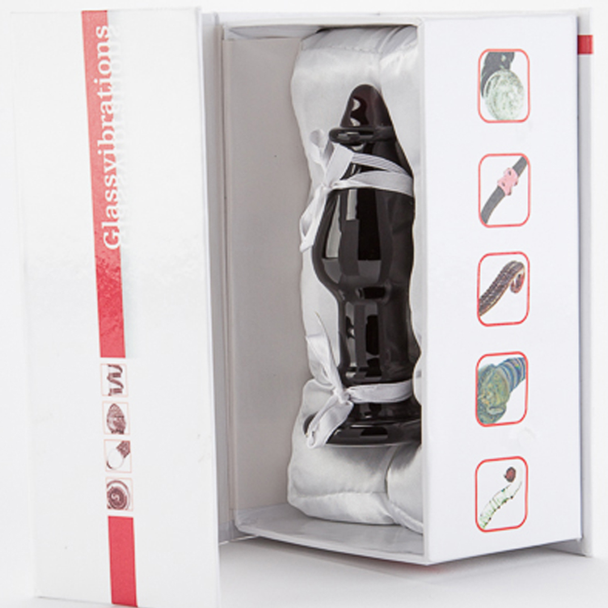 Glass Vibrations Sexspielzeug in einer weißen Box. Die Box ist geöffnet. Andere Sexspielzeuge rechts.