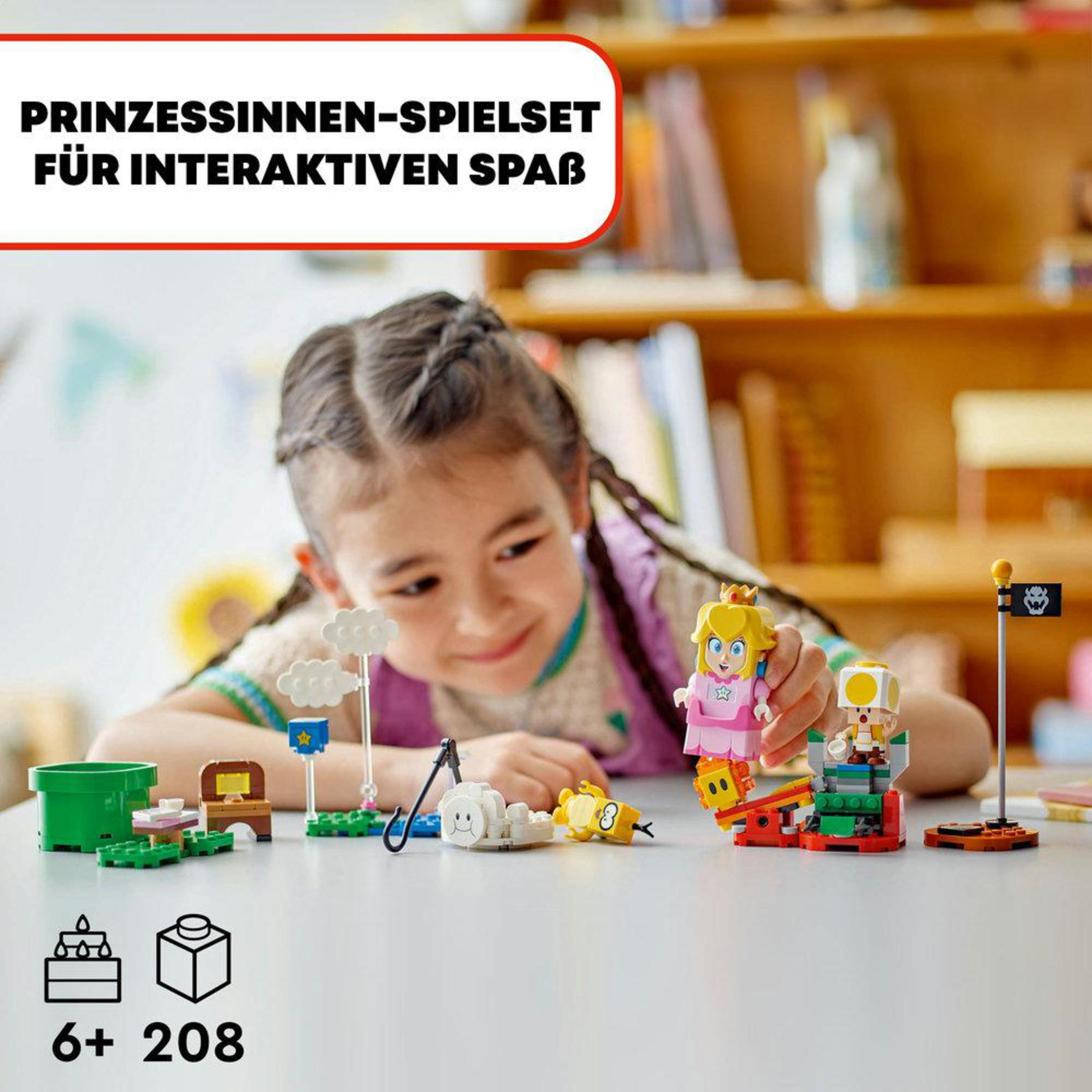 Fille jouant avec un set Lego, avec princesse et figurine Toad sur une table.