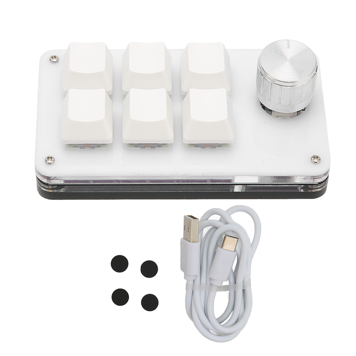 Eine weiße Tastatur mit sechs weißen Tasten und einem silbernen Knopf. Darunter ein USB-Kabel und vier schwarze Gummifüße.