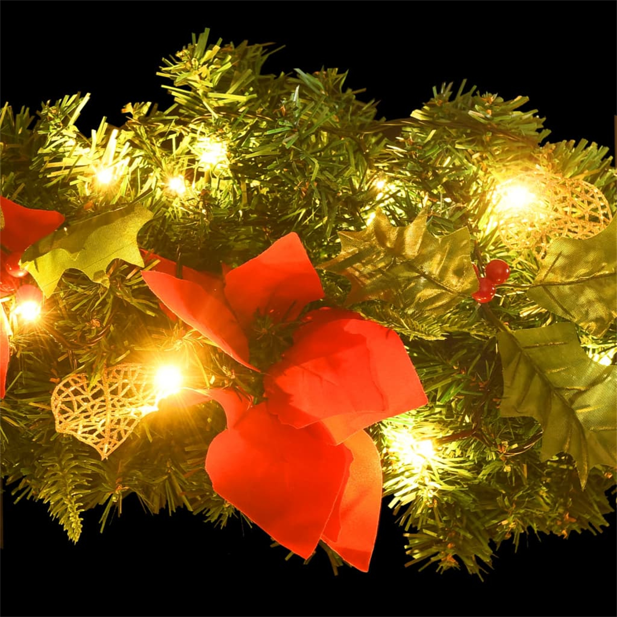 Weihnachtsgirlande mit roten Schleifen, goldenen Herzen und kleinen gelben Lichtern auf schwarzem Grund.