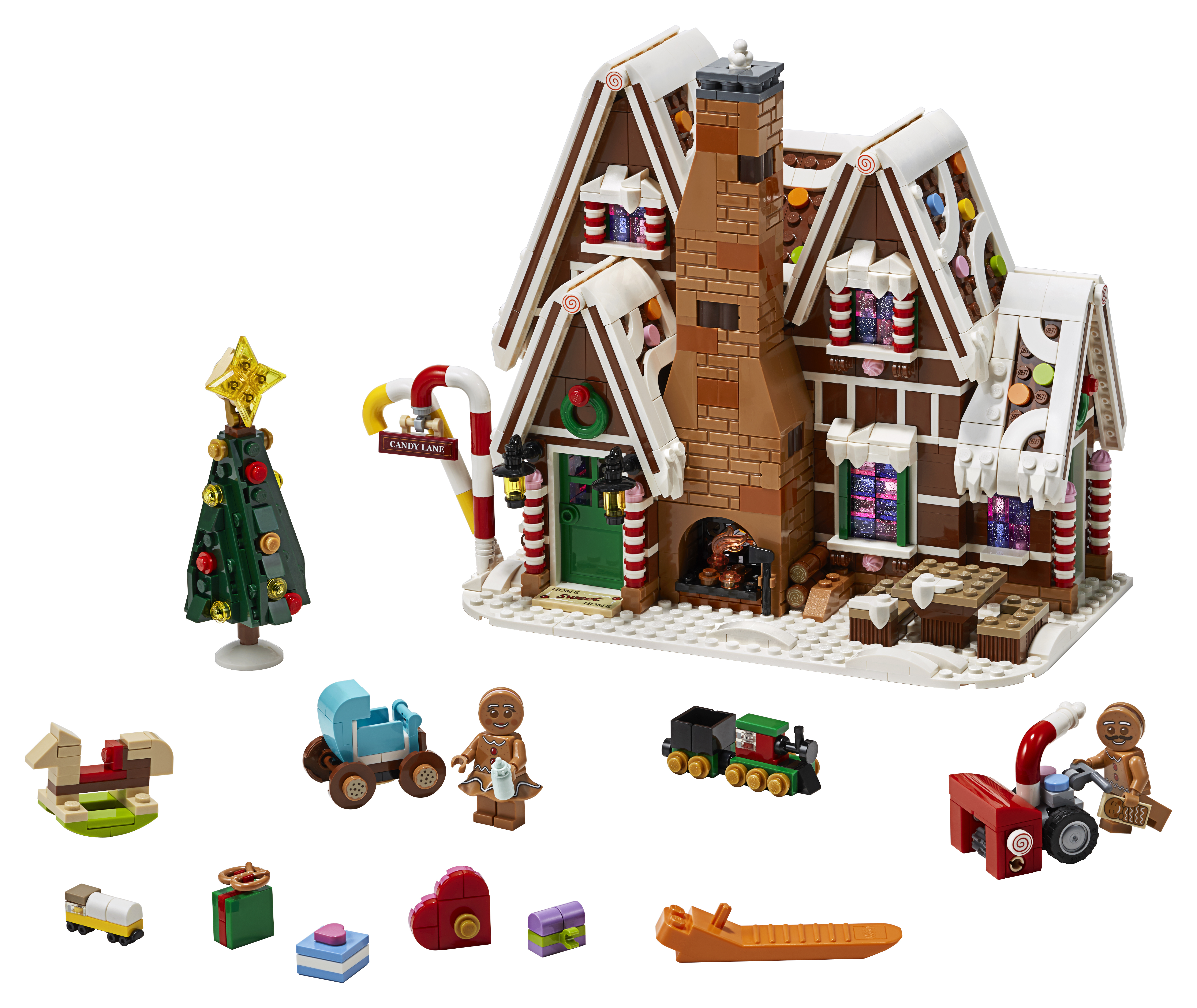 Una casa di pan di zenzero Lego con diverse piccole figure Lego e accessori come un albero di Natale e una slitta.