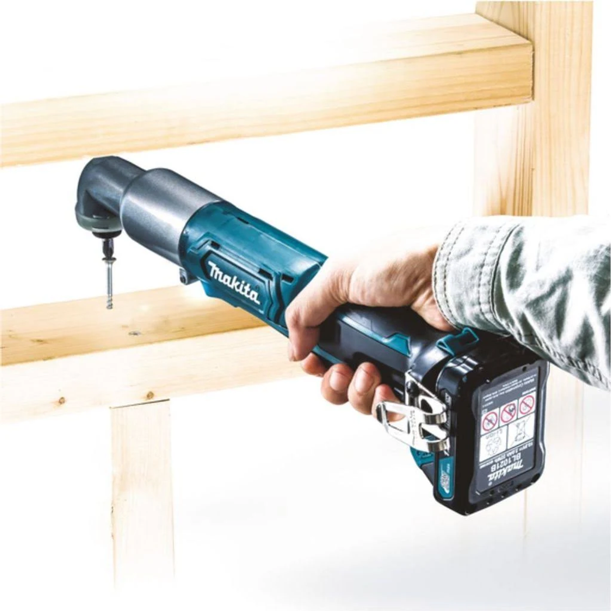 Taladro angular inalámbrico Makita atornillando en madera, usado por una persona.