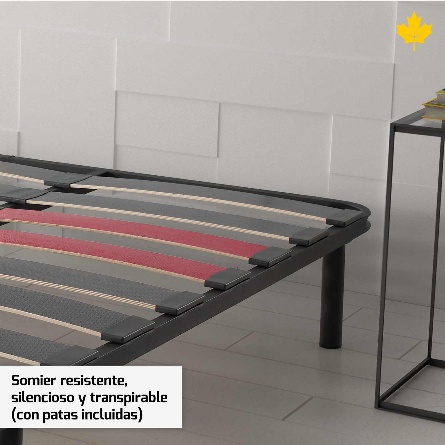 Un somier con marco negro, lamas rojas y una pared blanca al fondo.