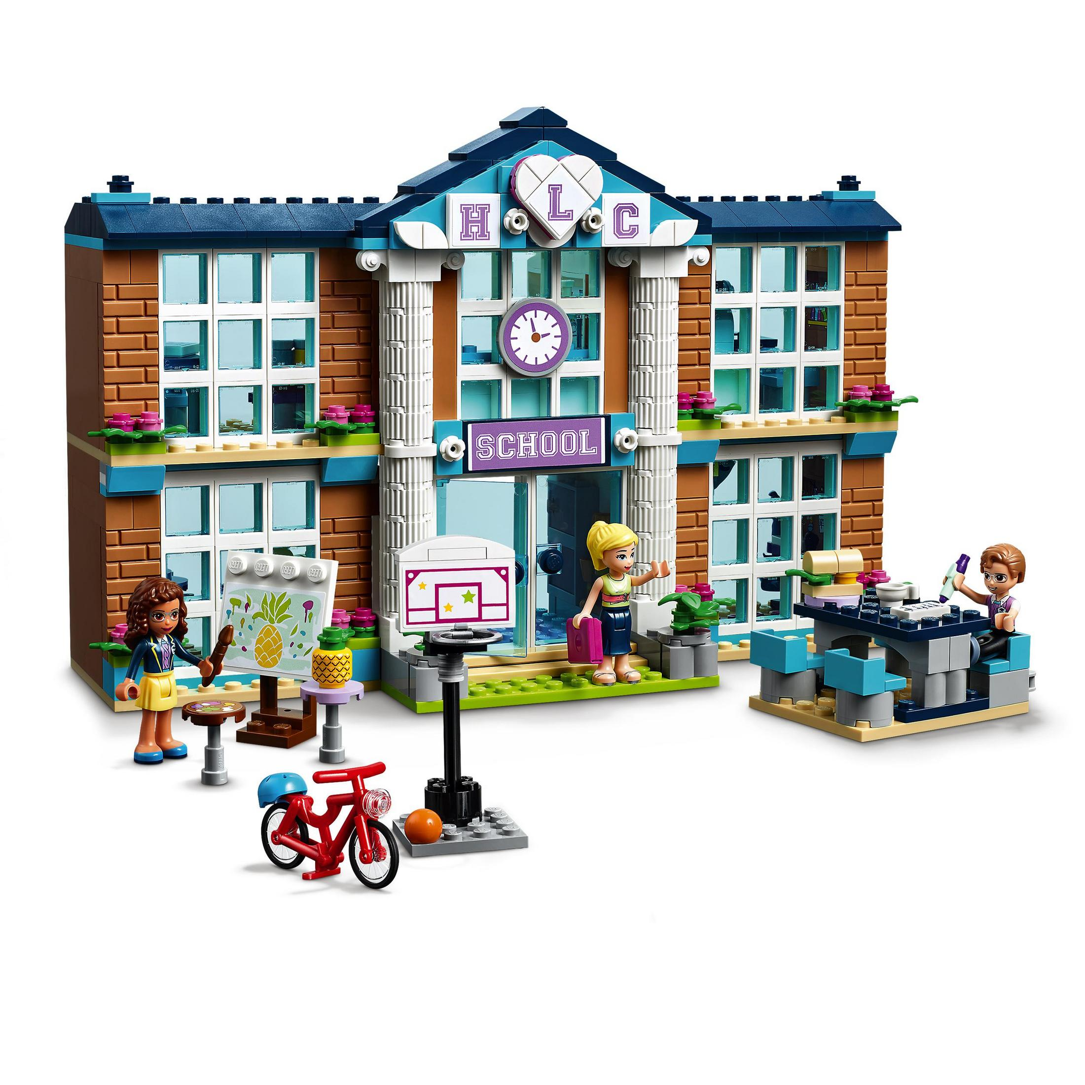 Lego-Schulgebäude mit Figuren; ein Mädchen zeichnet auf einer Staffelei, andere an einem Tisch, und ein Fahrrad.