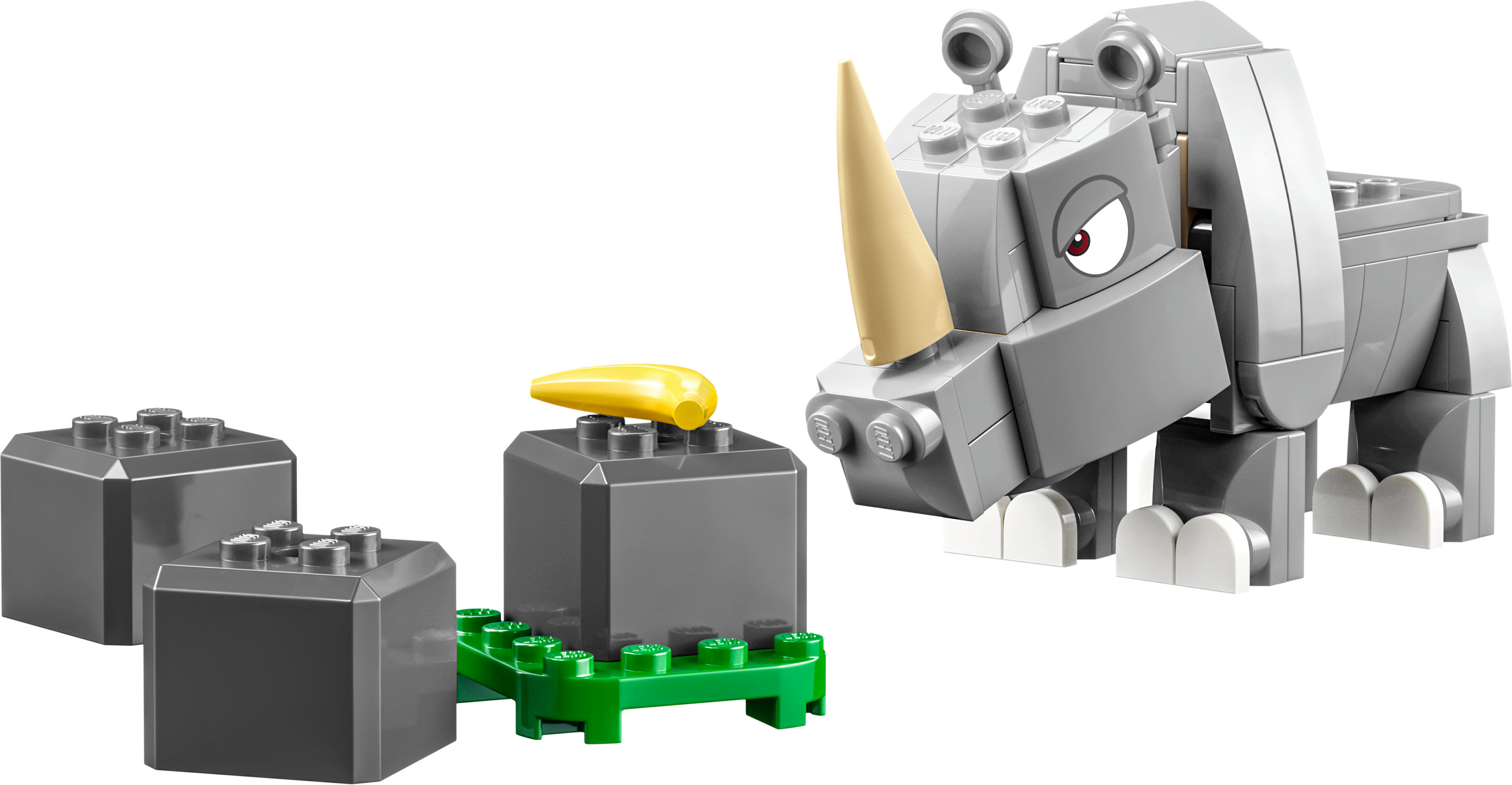 Giocattolo Lego rinoceronte. Modello di rinoceronte grigio con corno beige, vicino ad alcuni blocchi grigi e una base verde.