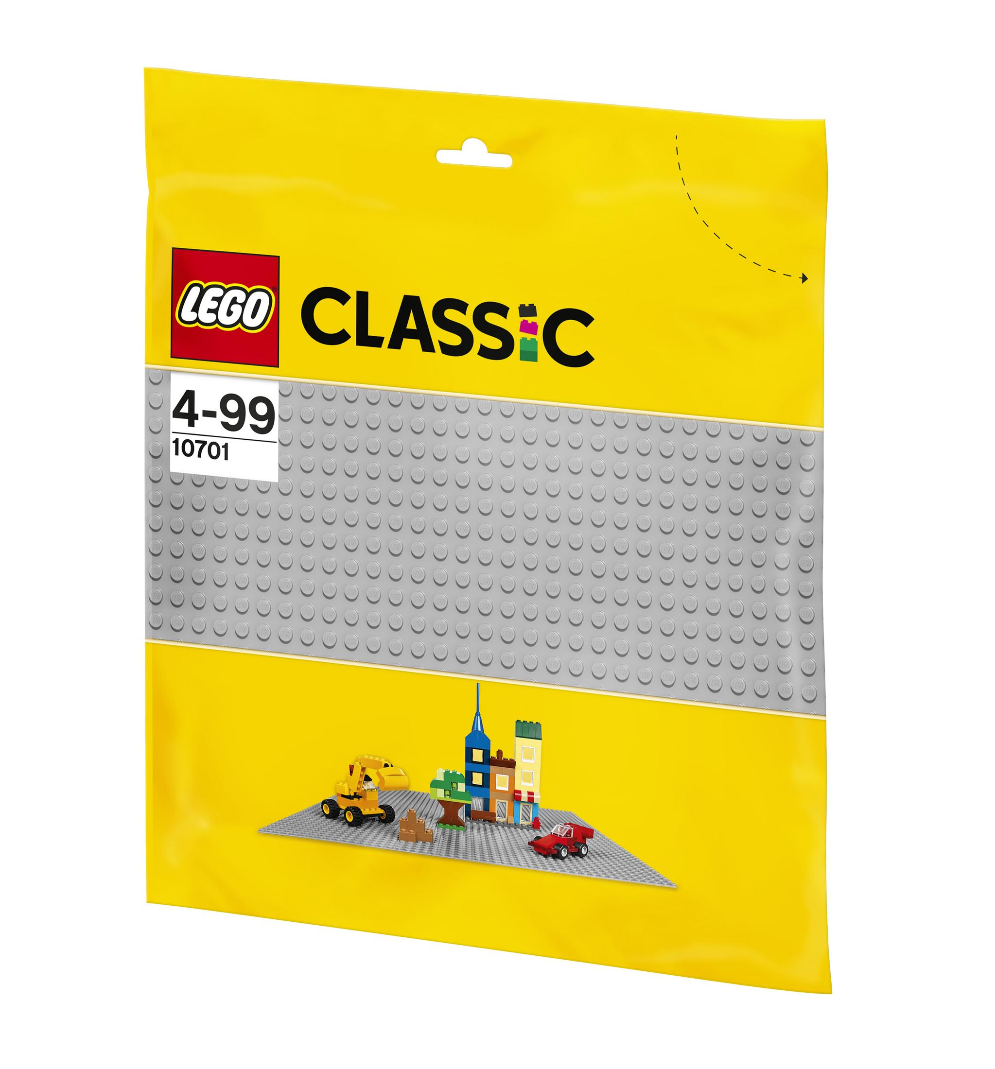 Żółta plastikowa torba z zestawem Lego Classic w środku, zawierająca szare płytki bazowe i małe modele Lego.