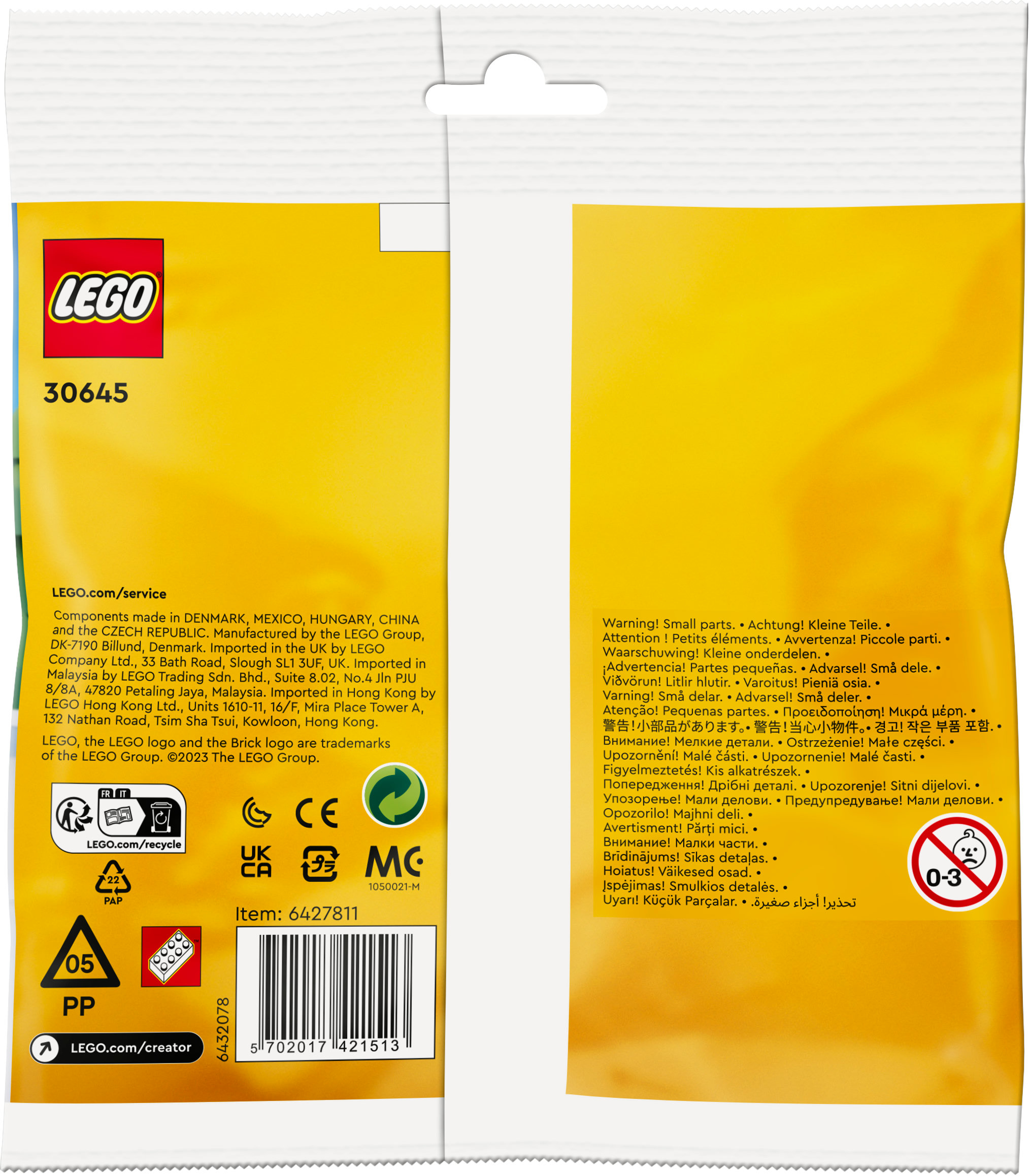 Metin ve uyarılar içeren küçük bir Lego yapı taşı çantası. Çanta beyaz ve yeşil, küçük Lego parçaları içeriyor.