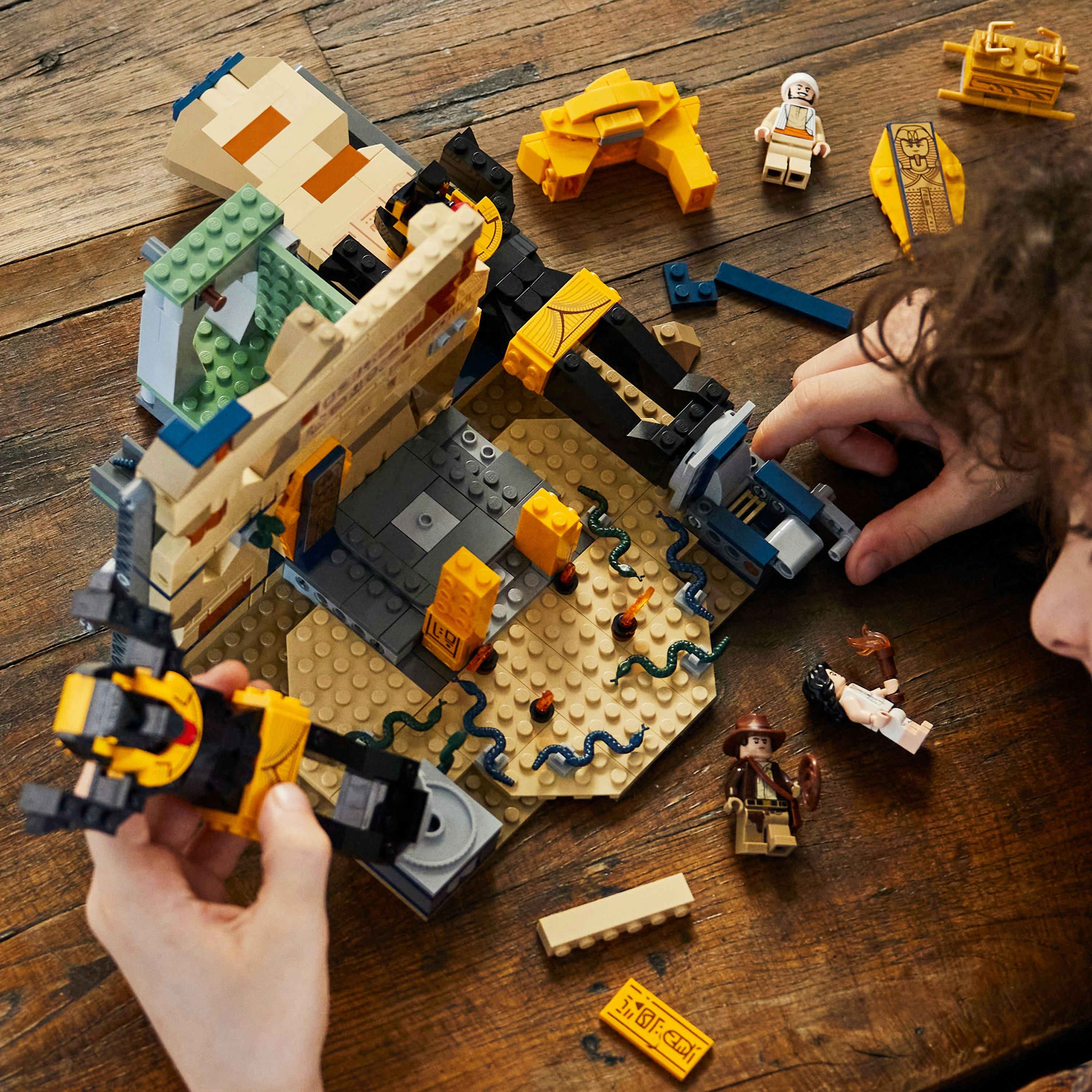 Un set Lego di una tomba egizia con personaggi, tra cui un esploratore e serpenti.