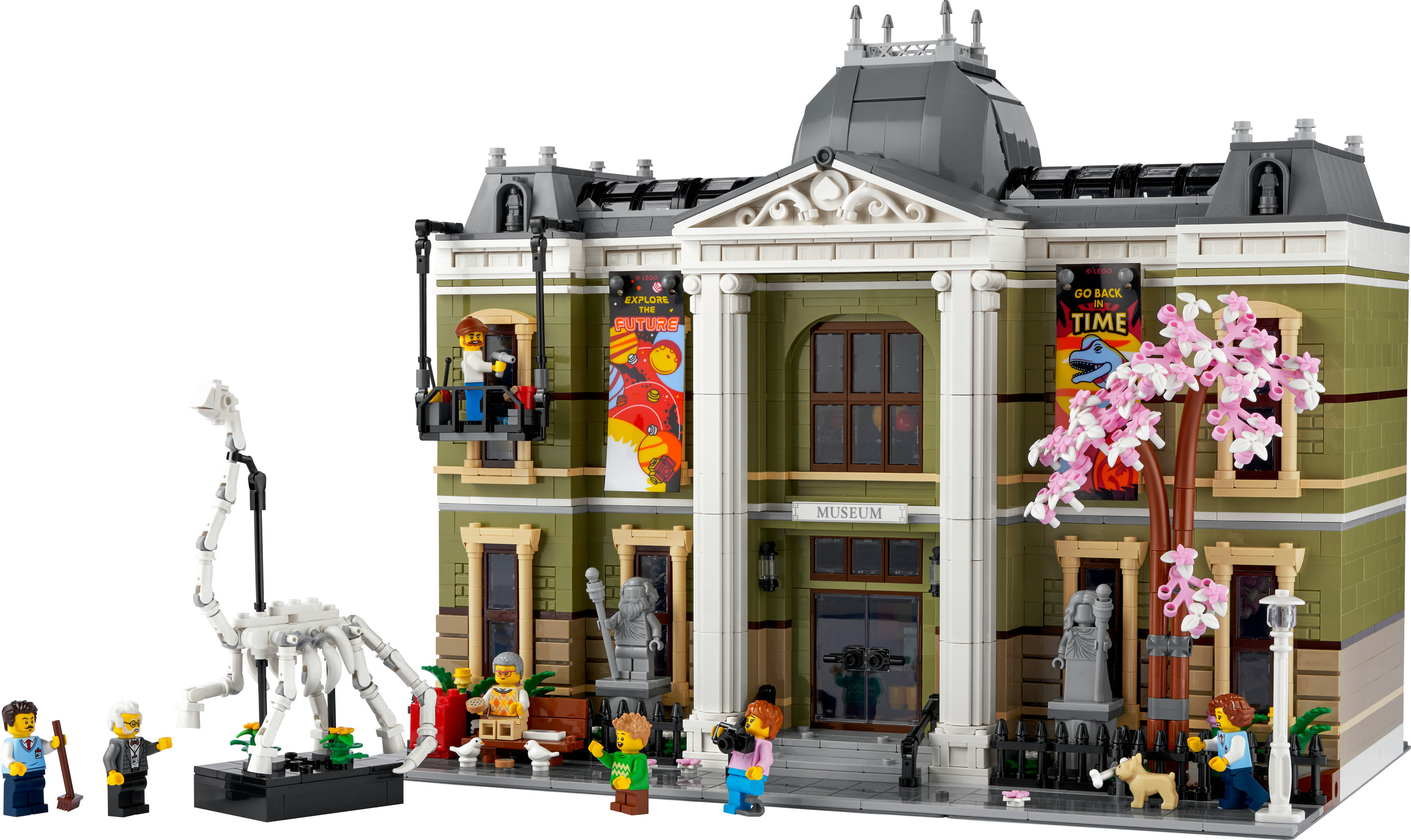 Model muzeum LEGO ze szkieletem dinozaura z przodu. Figurki ludzi rozmieszczone wokół muzeum.