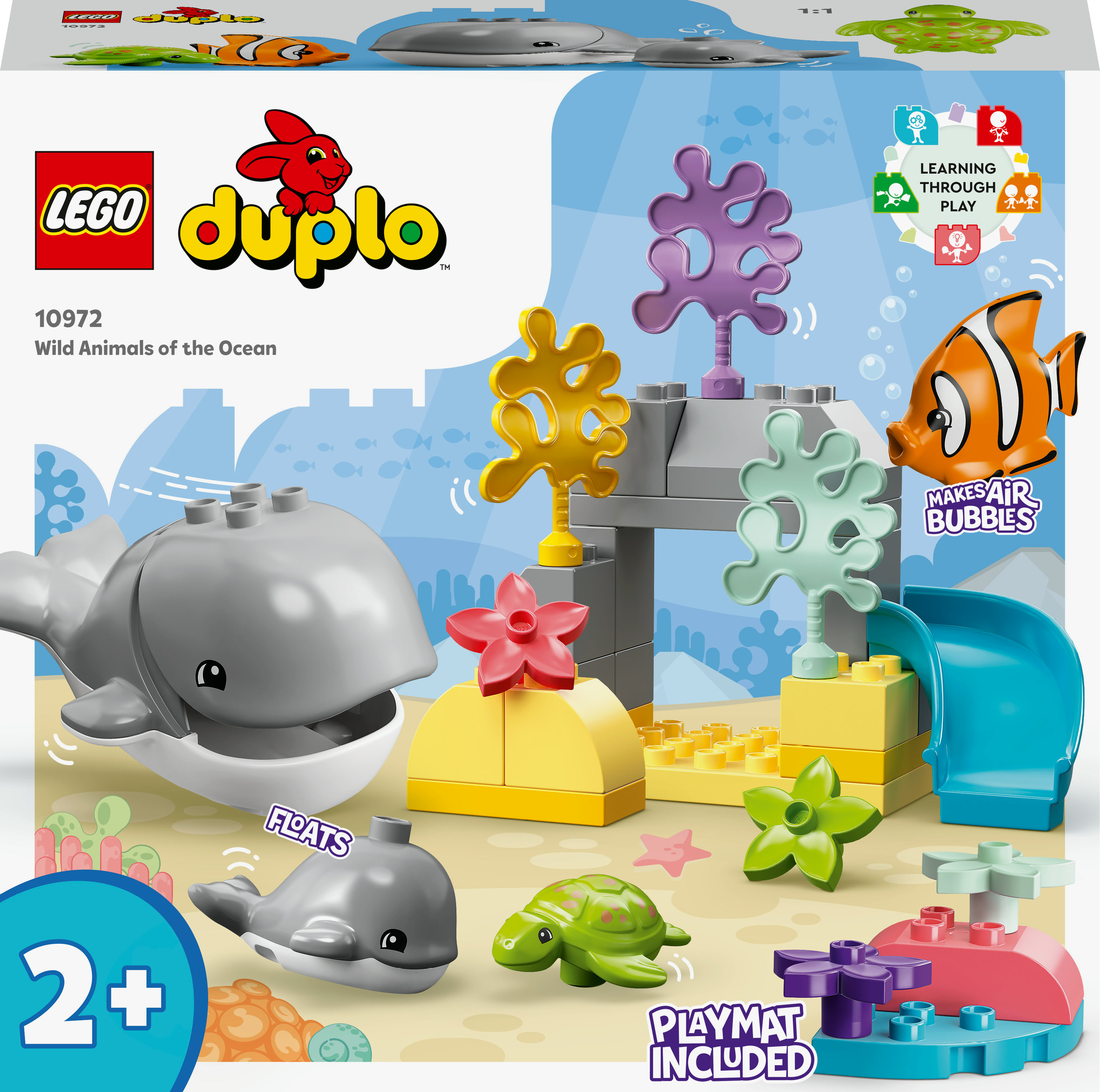 Ein Lego Duplo Set mit Wal, Fisch, Schildkröte und Korallen, mit Ozean-Hintergrund und Kartonoberseite.