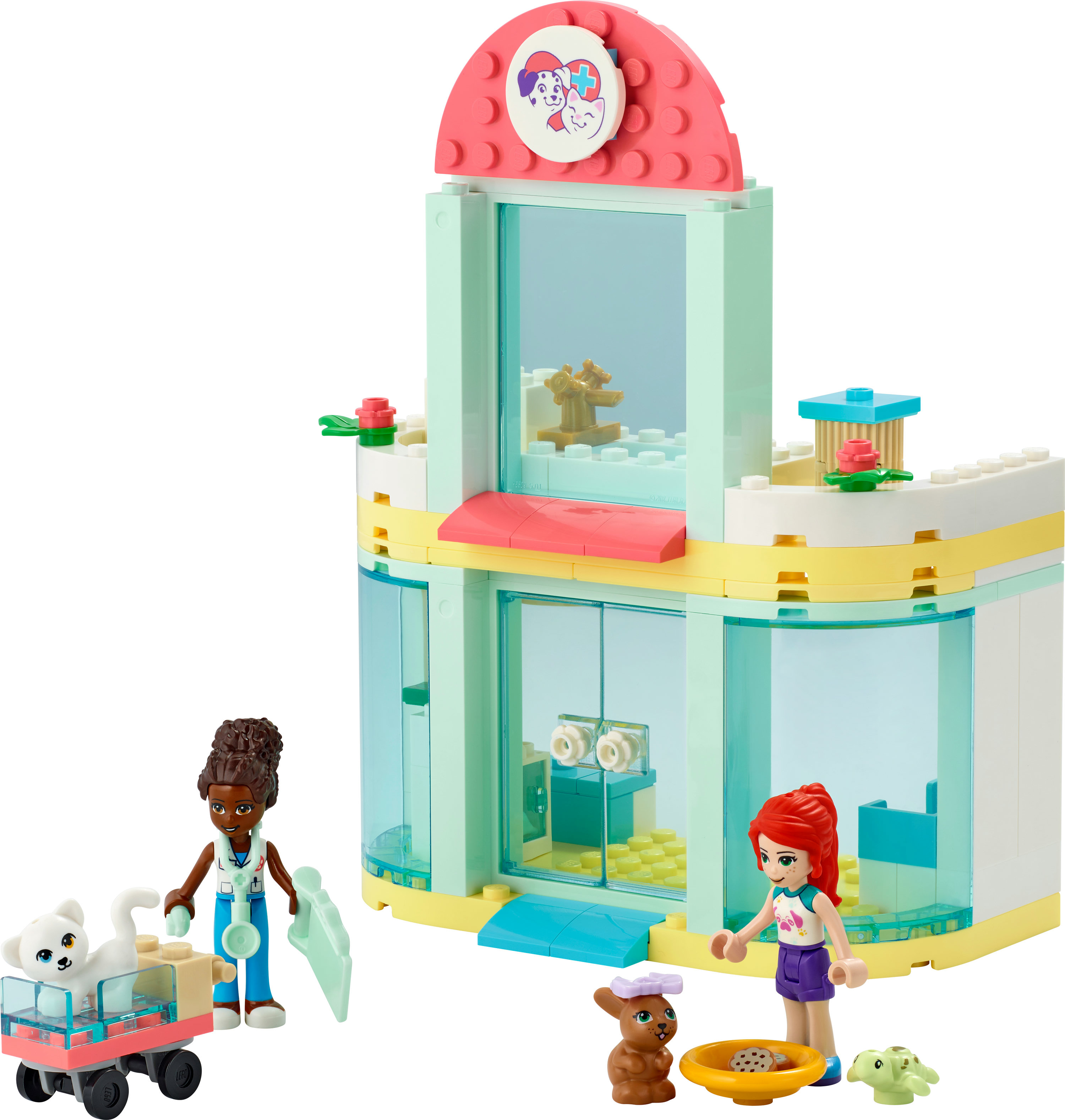 Lego Friends set. Gebouw met een dierenarts thema. Figuren van mensen en dieren. Roze kar aanwezig.