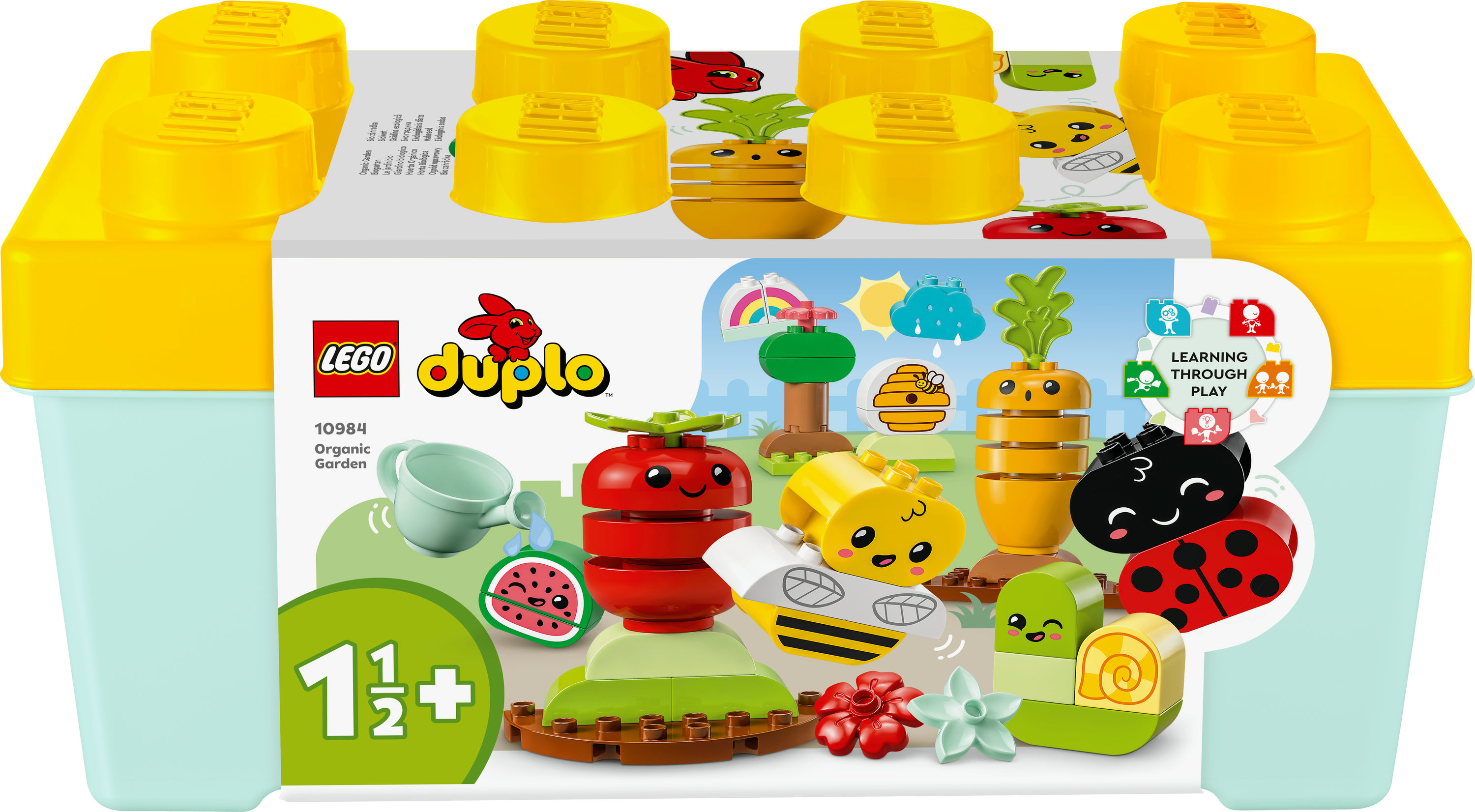 Pudełko LEGO Duplo z elementami ogrodu organicznego, w tym warzywami, ślimakiem, pszczołą i biedronką.