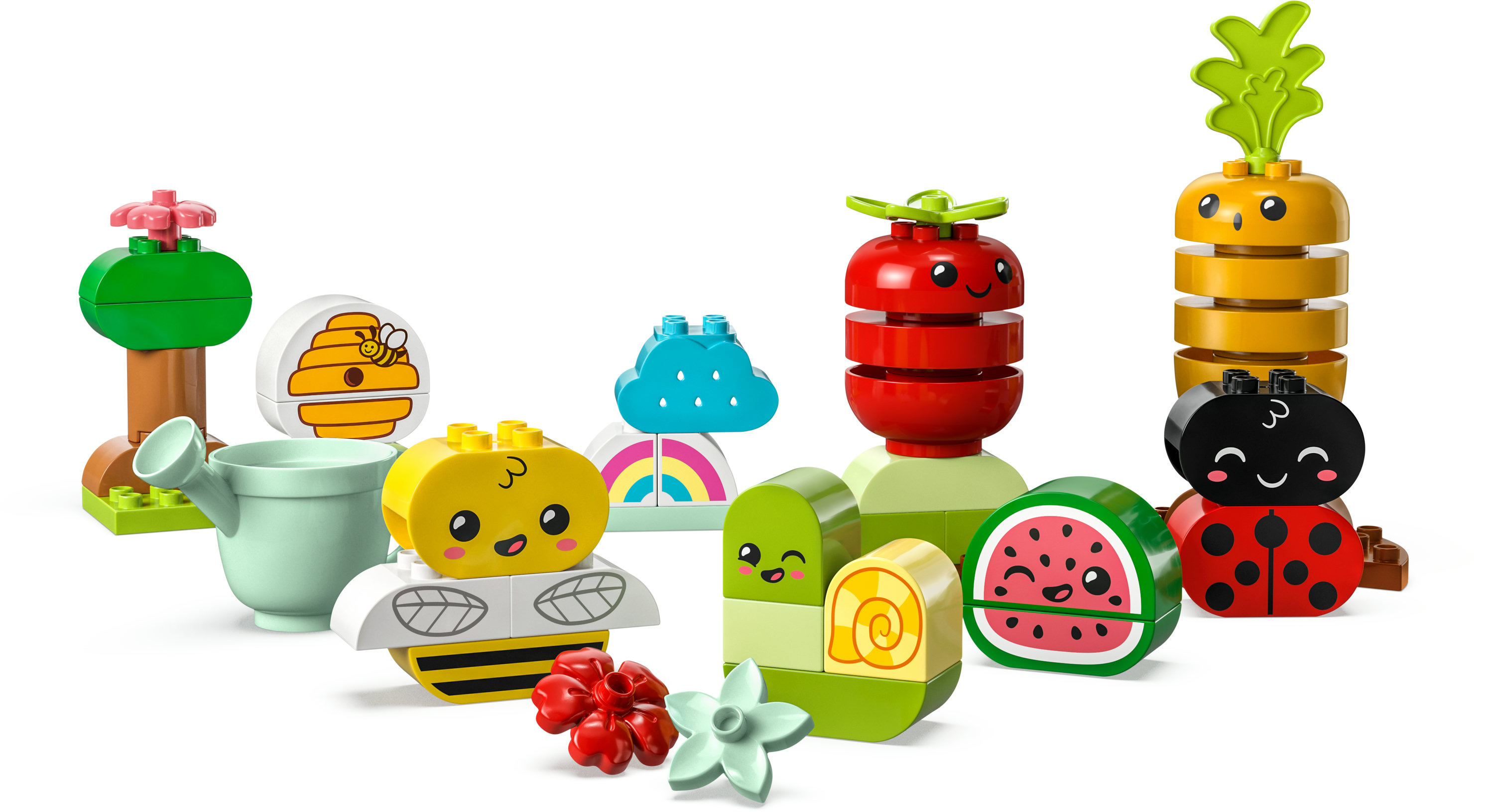 Zestaw LEGO DUPLO z różnymi uśmiechniętymi figurkami jedzenia i owadów na białym tle.