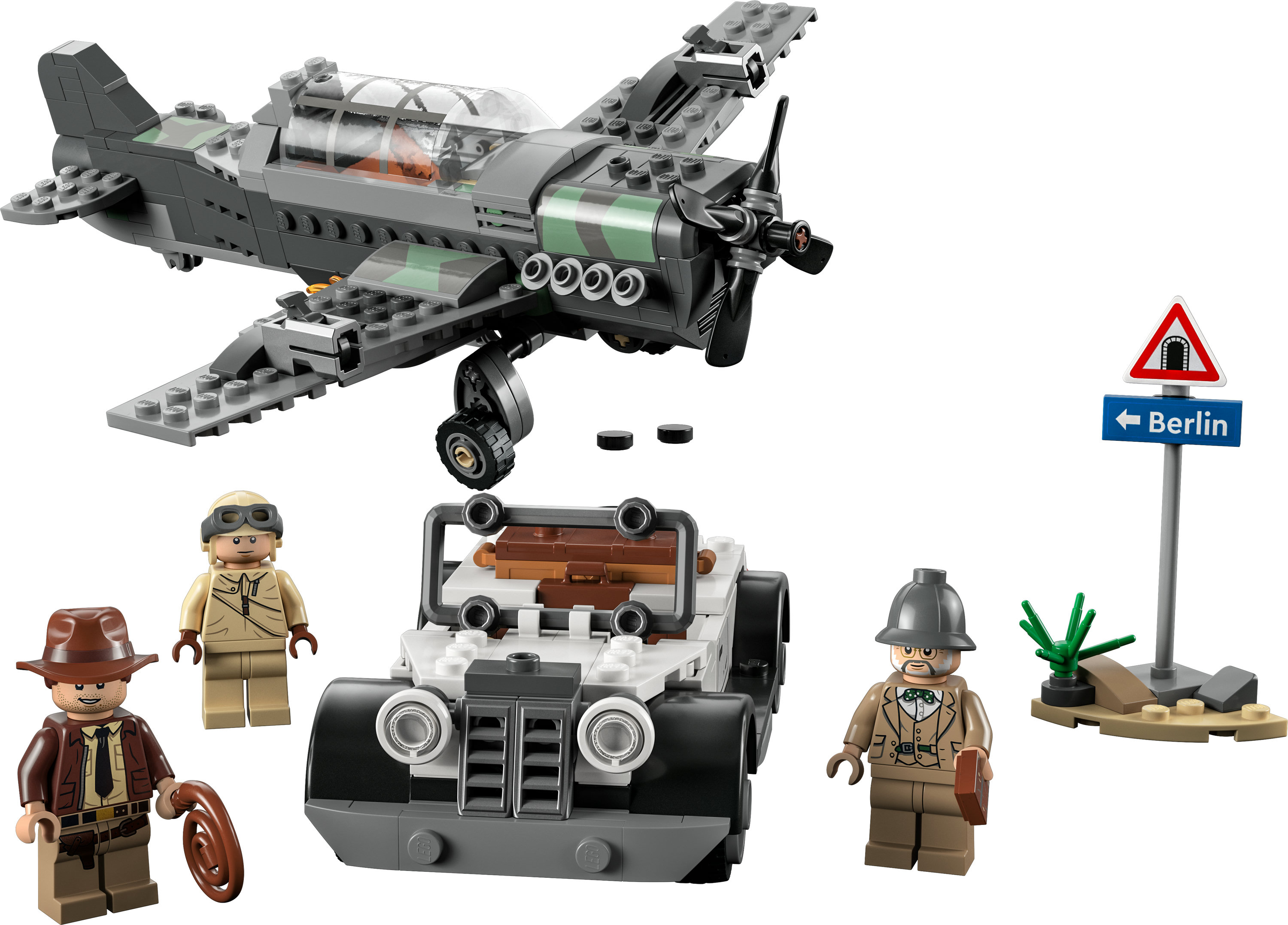 Set Lego con avión, jeep y figuras de aventureros y una señal de tráfico.