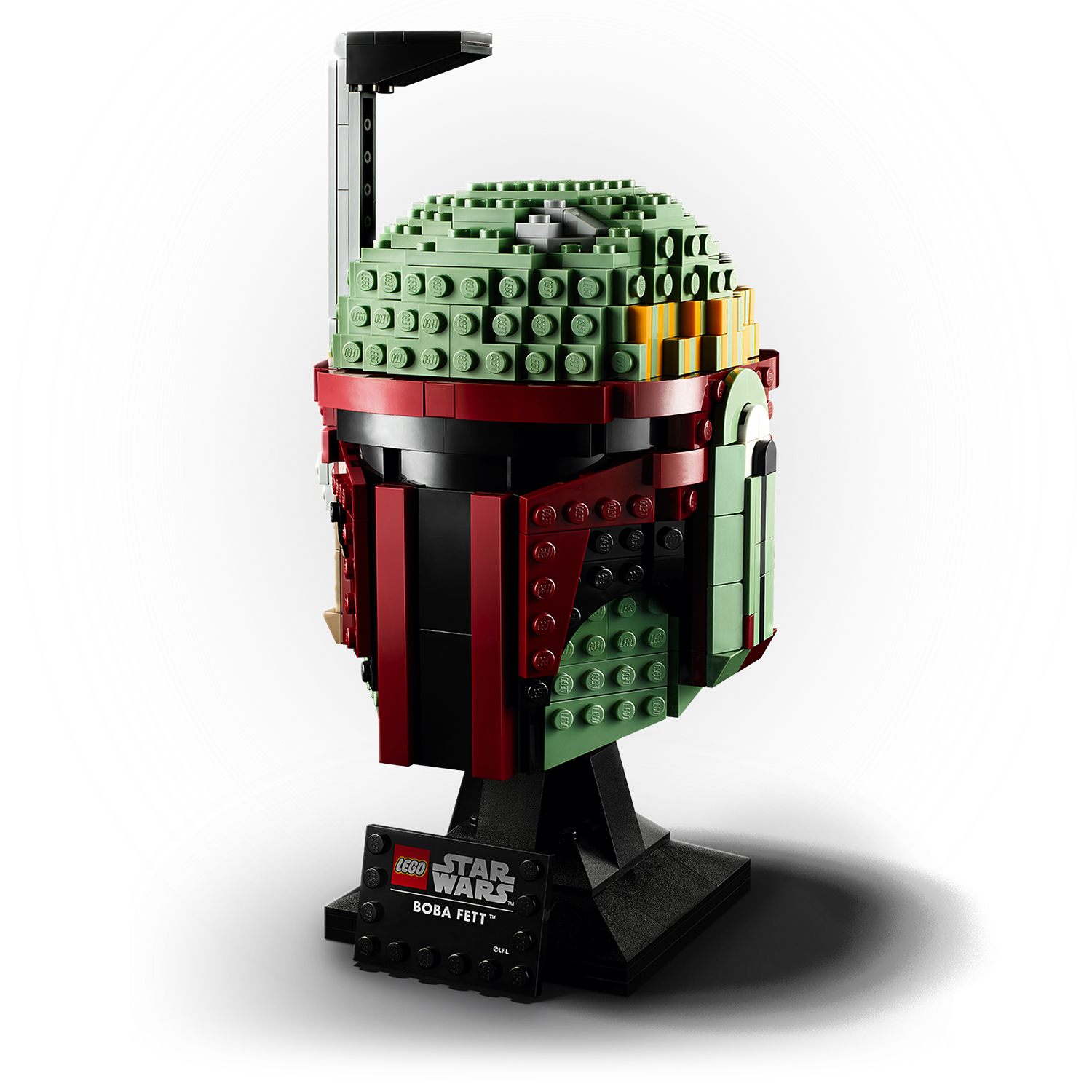 Kask Lego Boba Fetta na stojaku. Kask jest zielony, czerwony i czarny. Tło jest białe.
