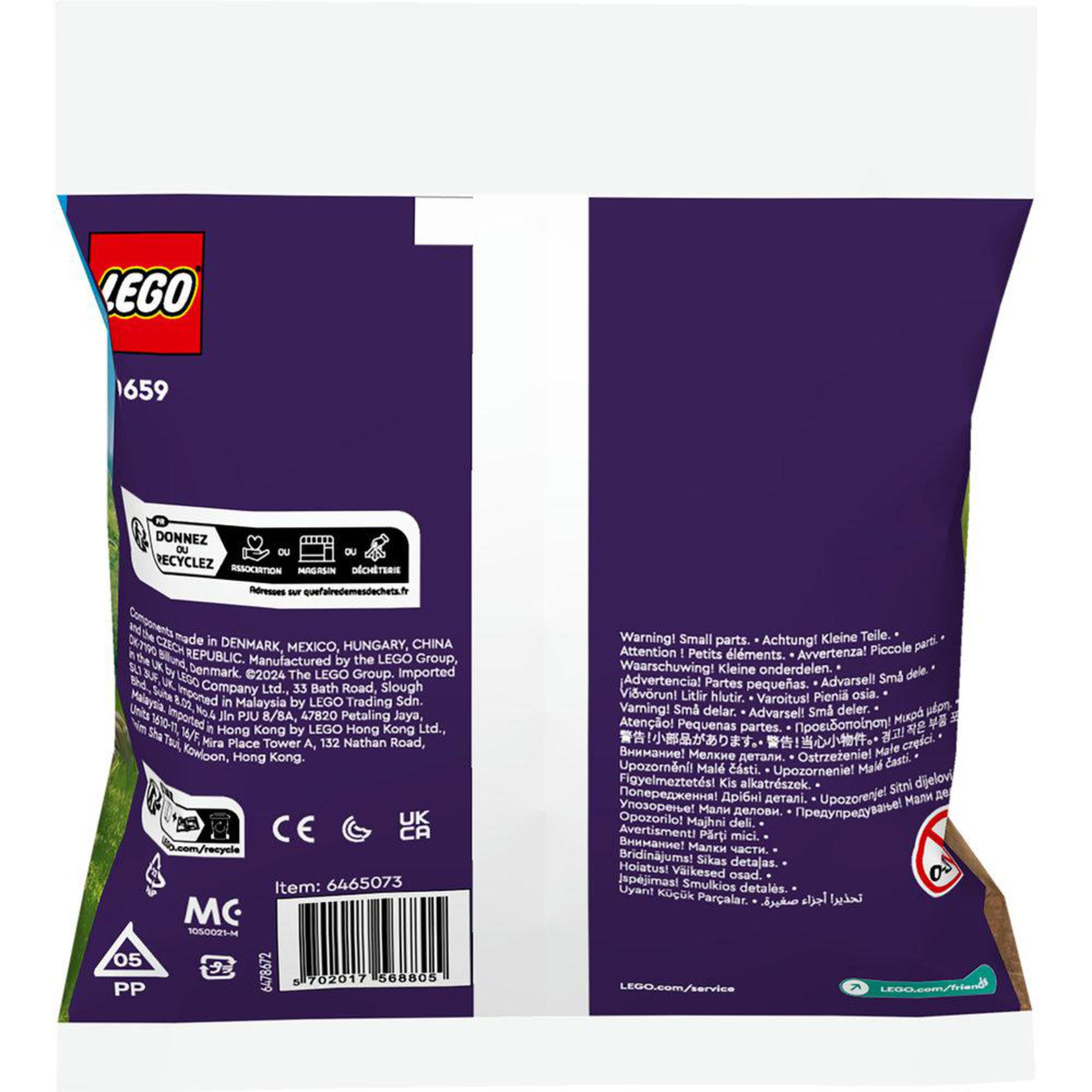 Eine LEGO-Tasche mit Text und Logos. Sie ist lila und grün. Auf der Tasche steht 'Donnez Recycler'.