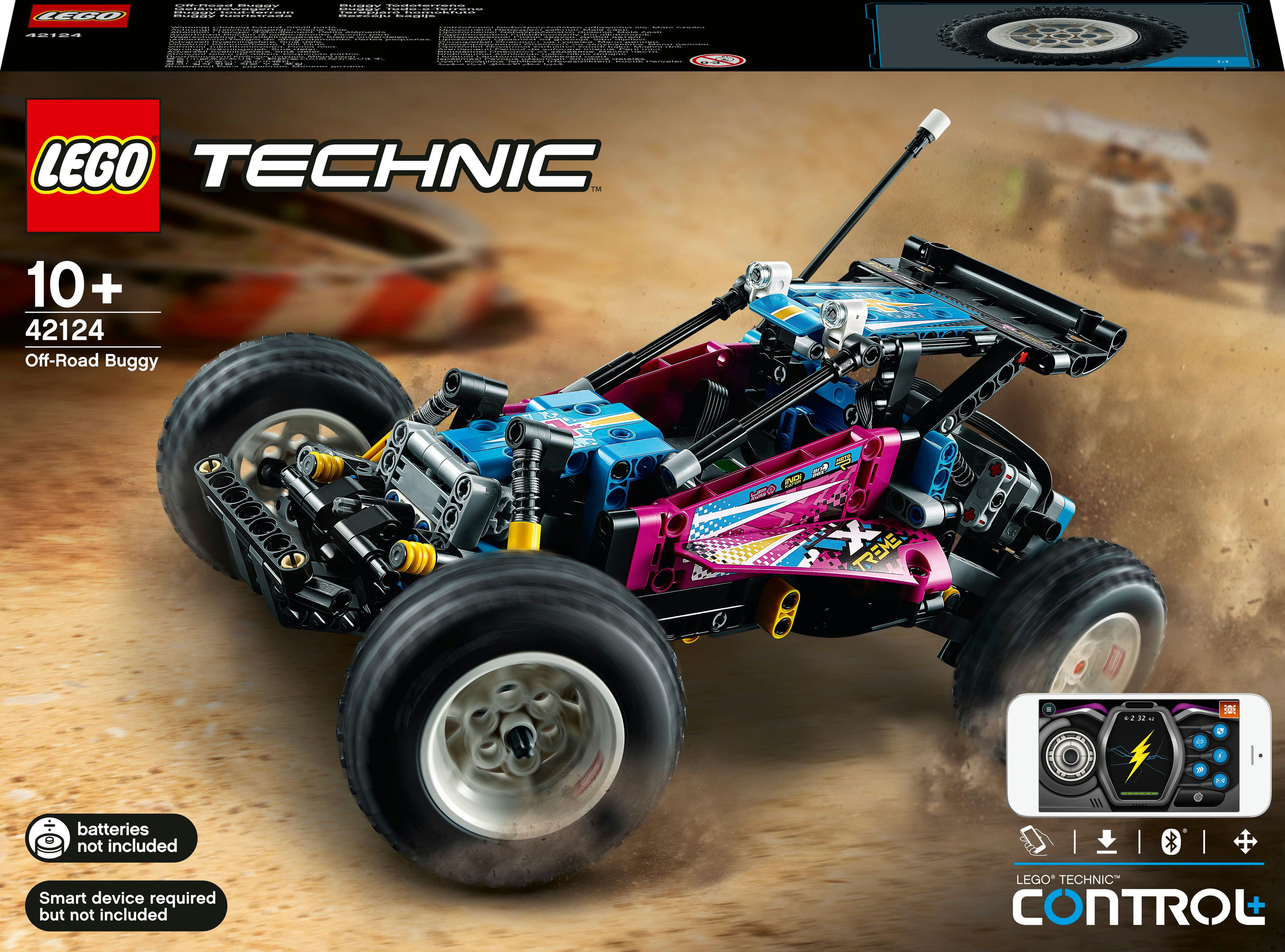 Kumlu bir yüzeyde Lego Technic arazi arabası. Araba mavi, pembe ve siyah, bir kontrol cihazıyla.