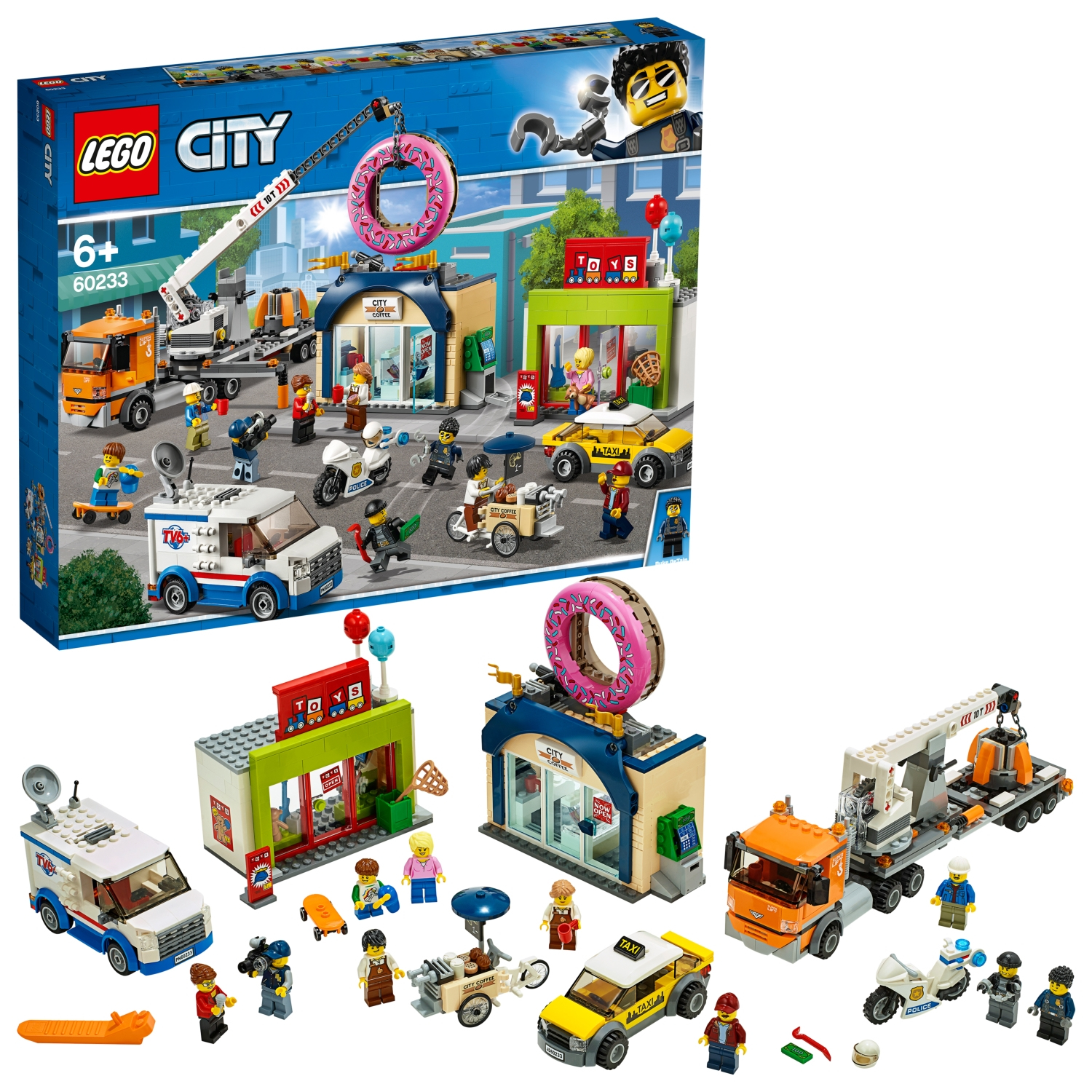 Set Lego City: Vari edifici, veicoli e minifigure. Un negozio di ciambelle è in evidenza. Scena luminosa e colorata.