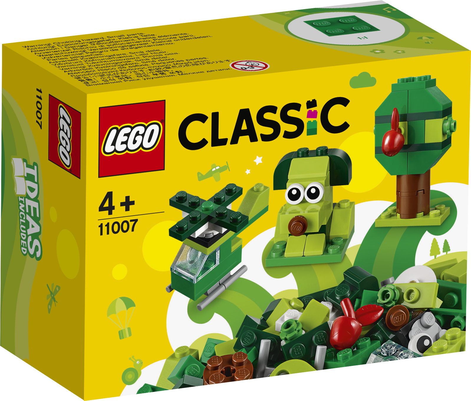 Una scatola Lego Classic mostra un elicottero, un cane, un albero ed erba verde.