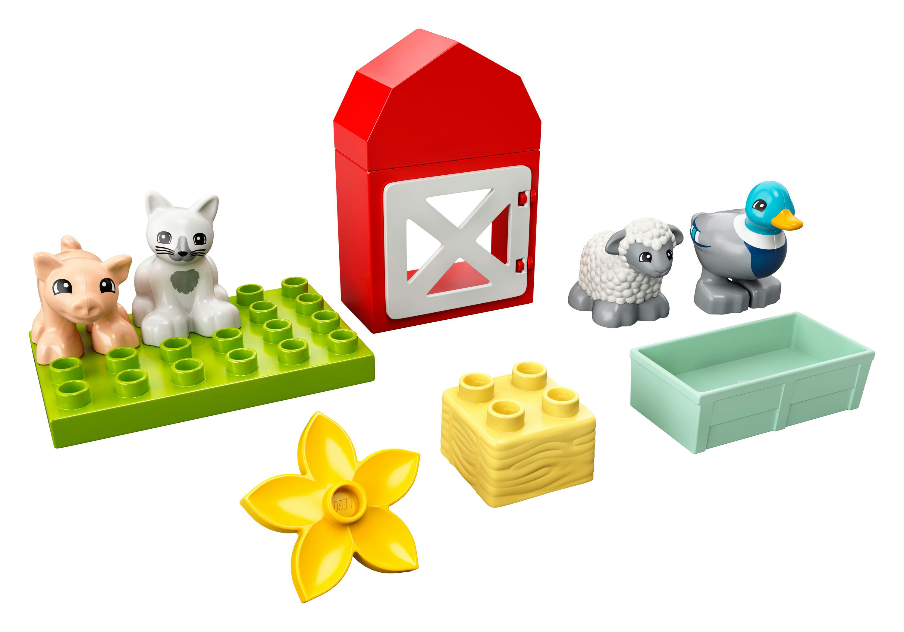 Lego Duplo Bauernhof-Set mit roter Scheune, Tieren und Zubehör auf weißem Hintergrund.