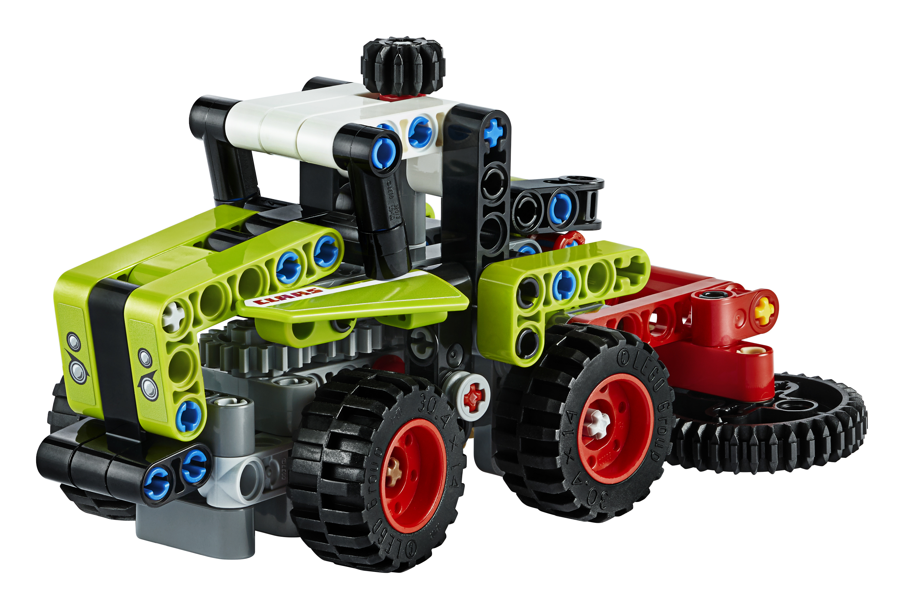 A LEGO Technic tractor model in green and black with a red mowing attachment.
