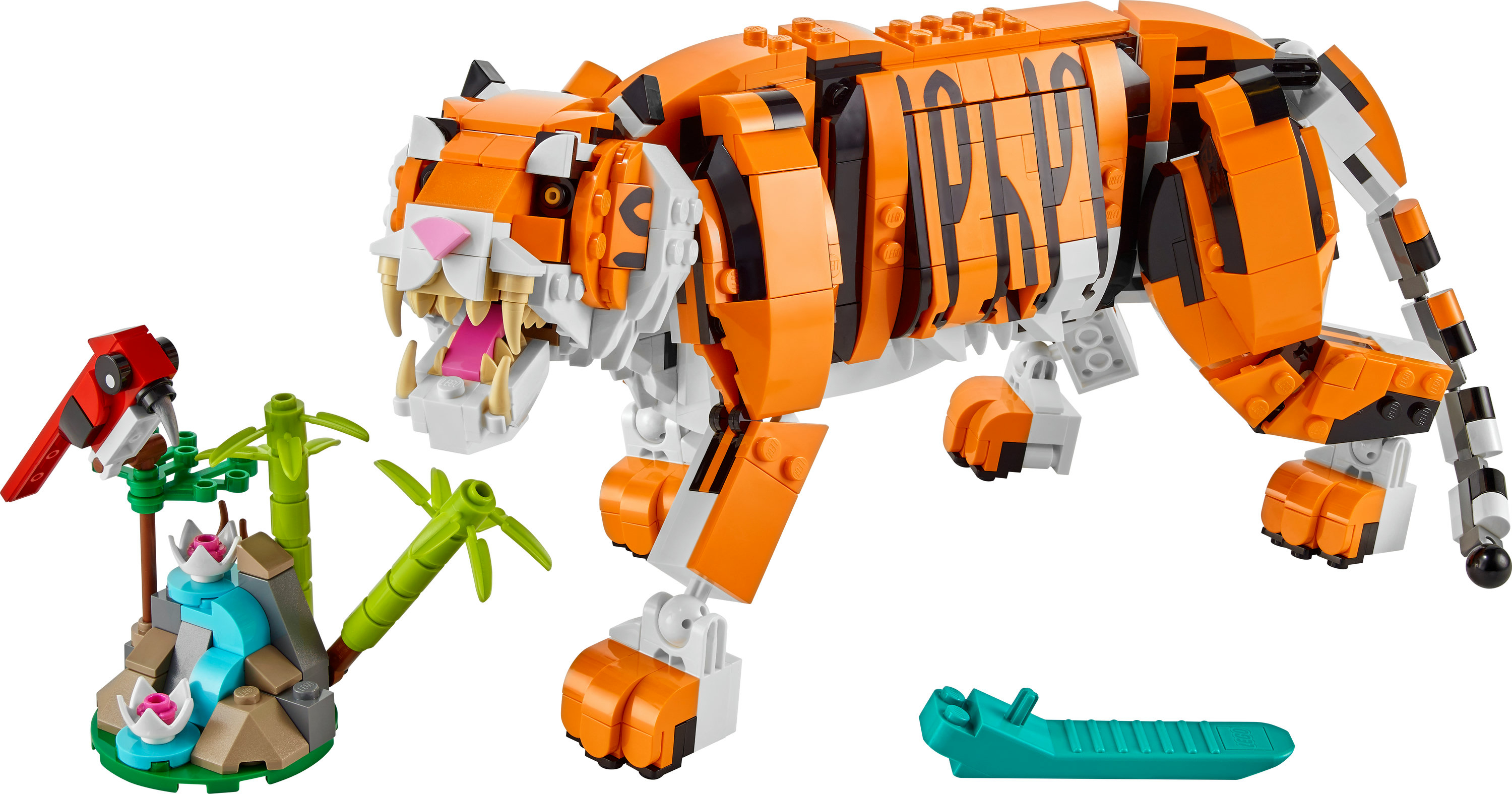 Lego kaplan seti. Siyah çizgili büyük bir turuncu kaplan, bir kuş ve küçük bir orman sahnesi.