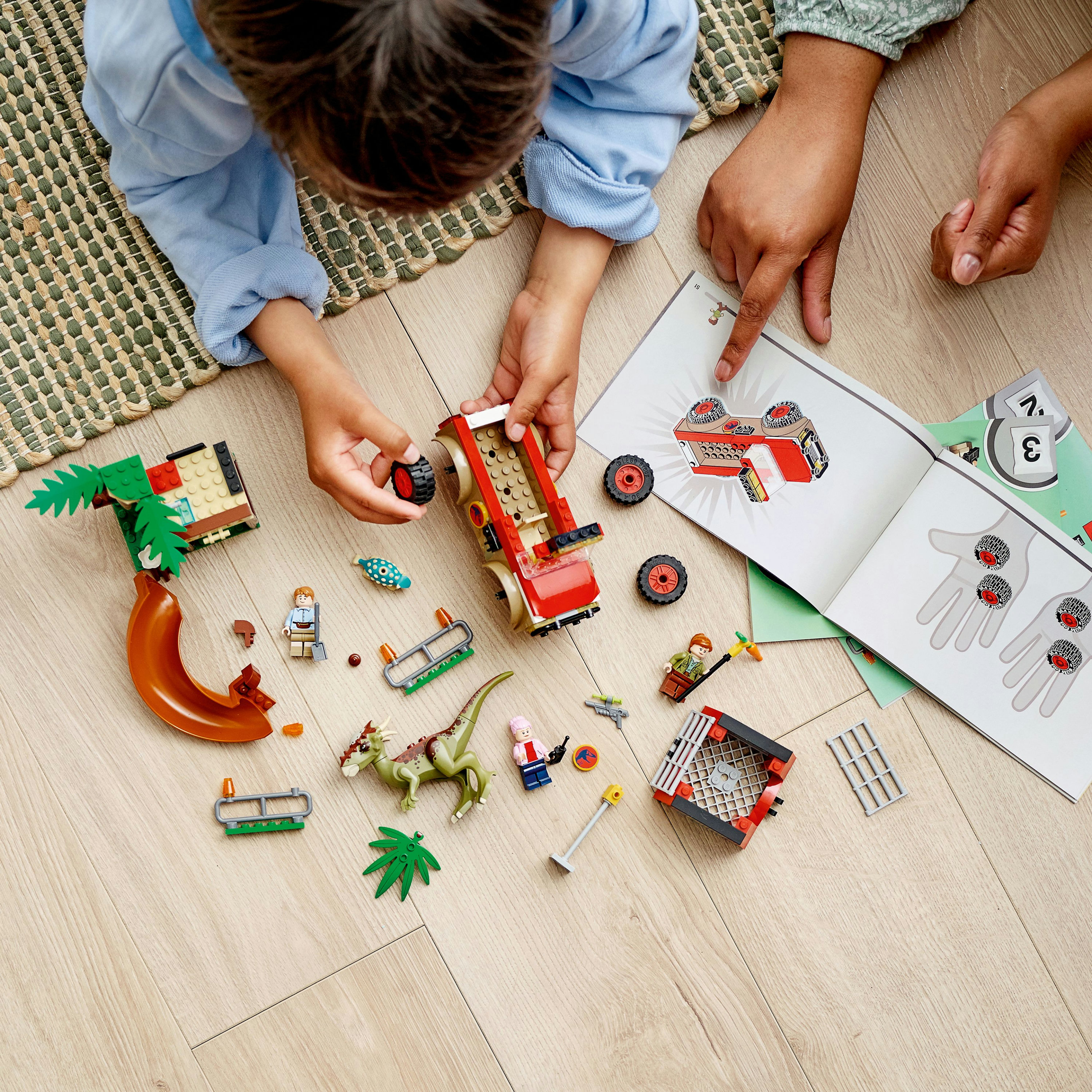 Eine Lego Jurassic Park Szene mit Jeep, Dinosaurier und Figuren, mit Bauanleitung.