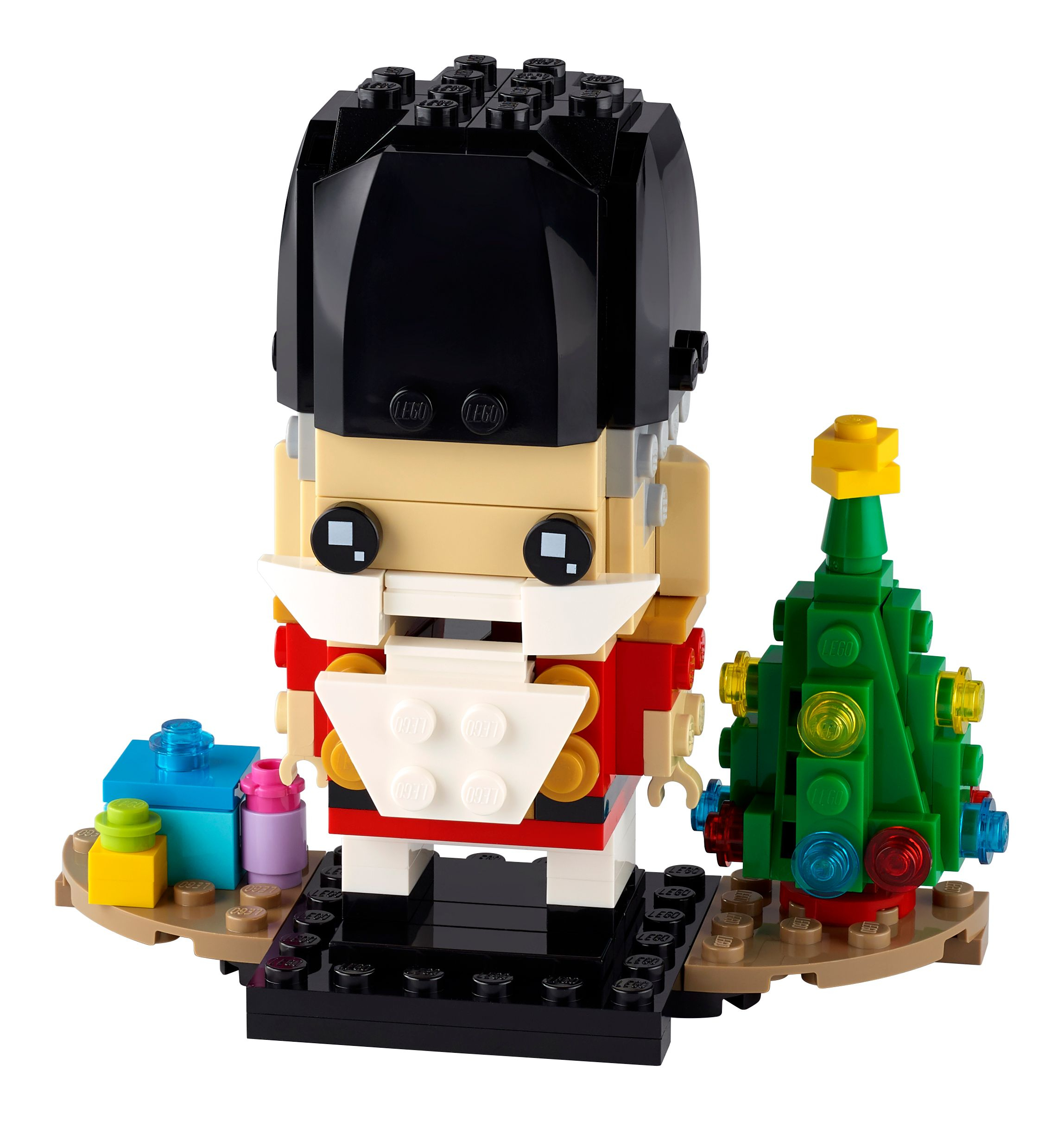 A Lego Nutcracker model with a Christmas tree and gift boxes.