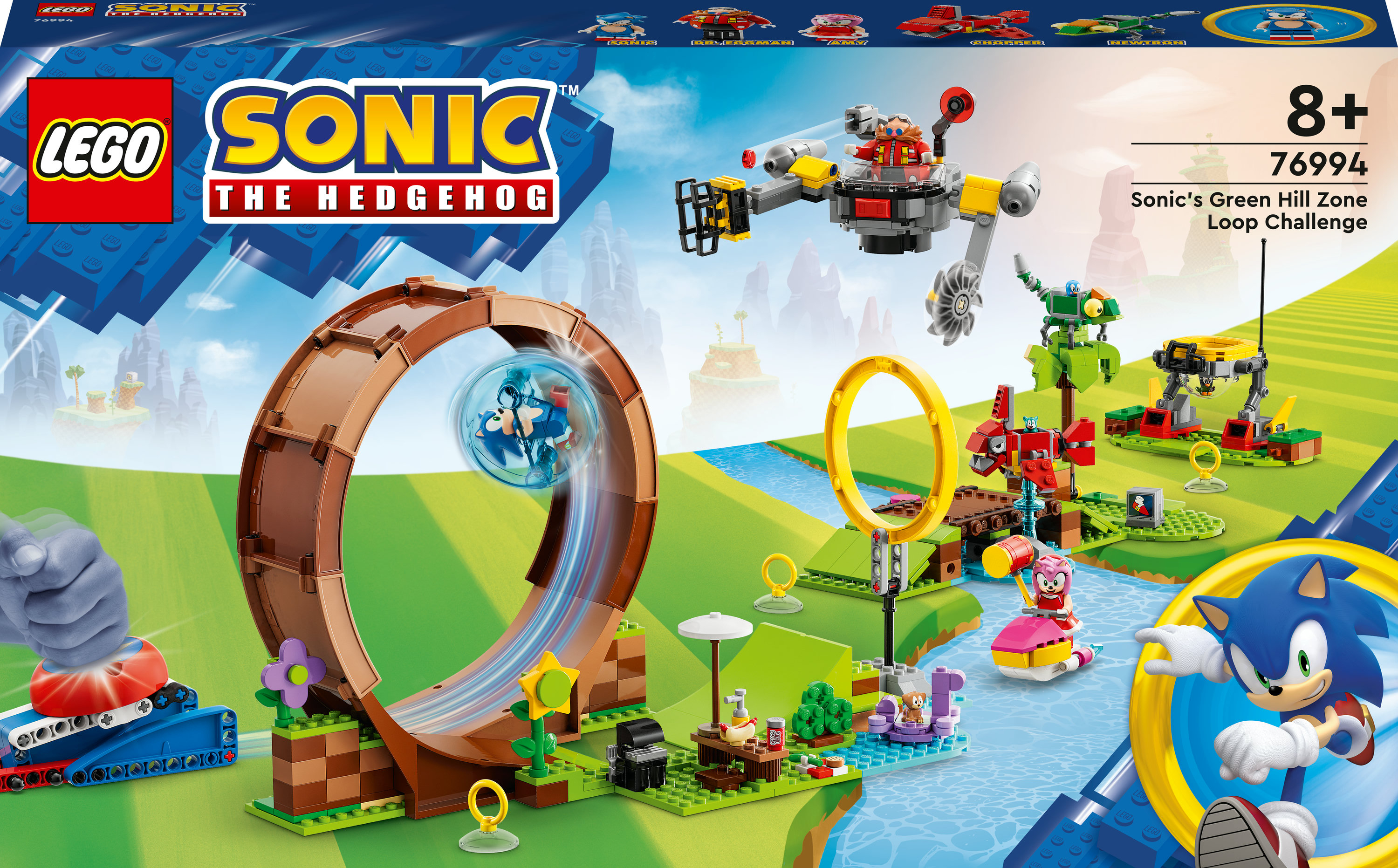 Lego Sonic the Hedgehog Set-Box mit einer Schleife, Figuren und einer lebendigen grünen Landschaft.