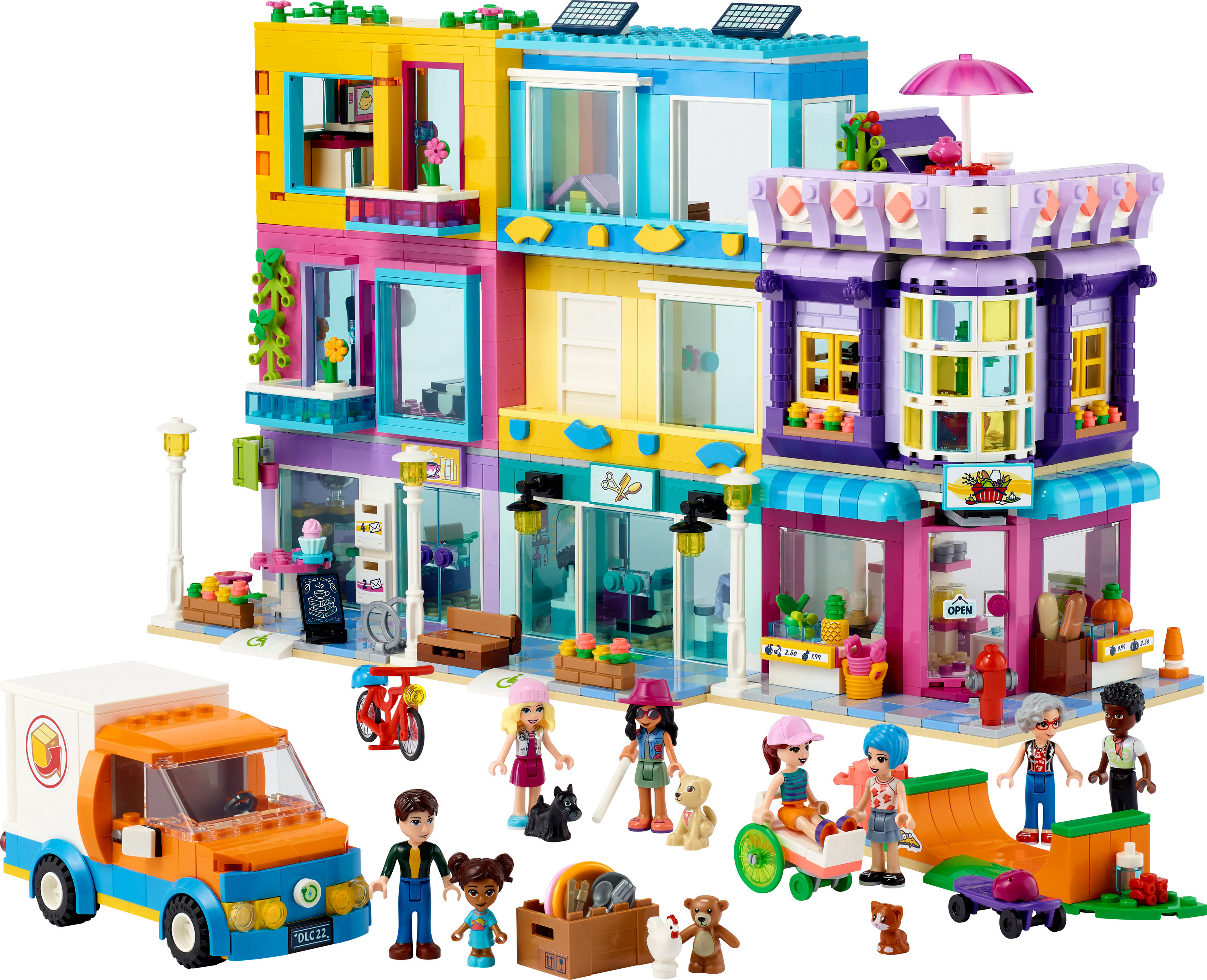 Een Lego Friends set van een gebouw met meerdere verdiepingen, winkels, mensen en een vrachtwagen. Het is speelgoed.