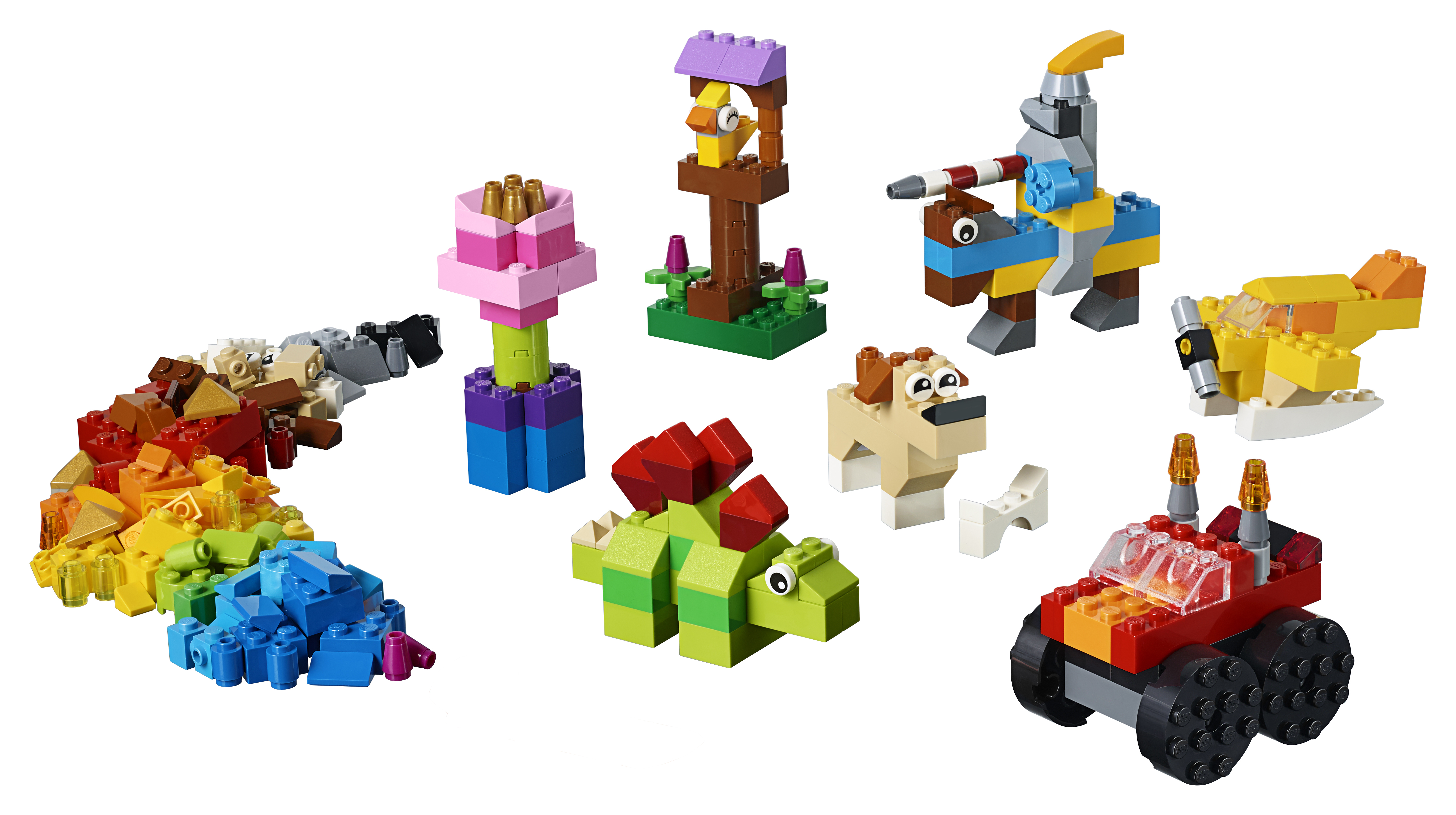 Ein Lego Classic Set mit verschiedenen bunten Objekten: einer Blume, einem Vogel, einem Auto, einem Hund und einem Dinosaurier.