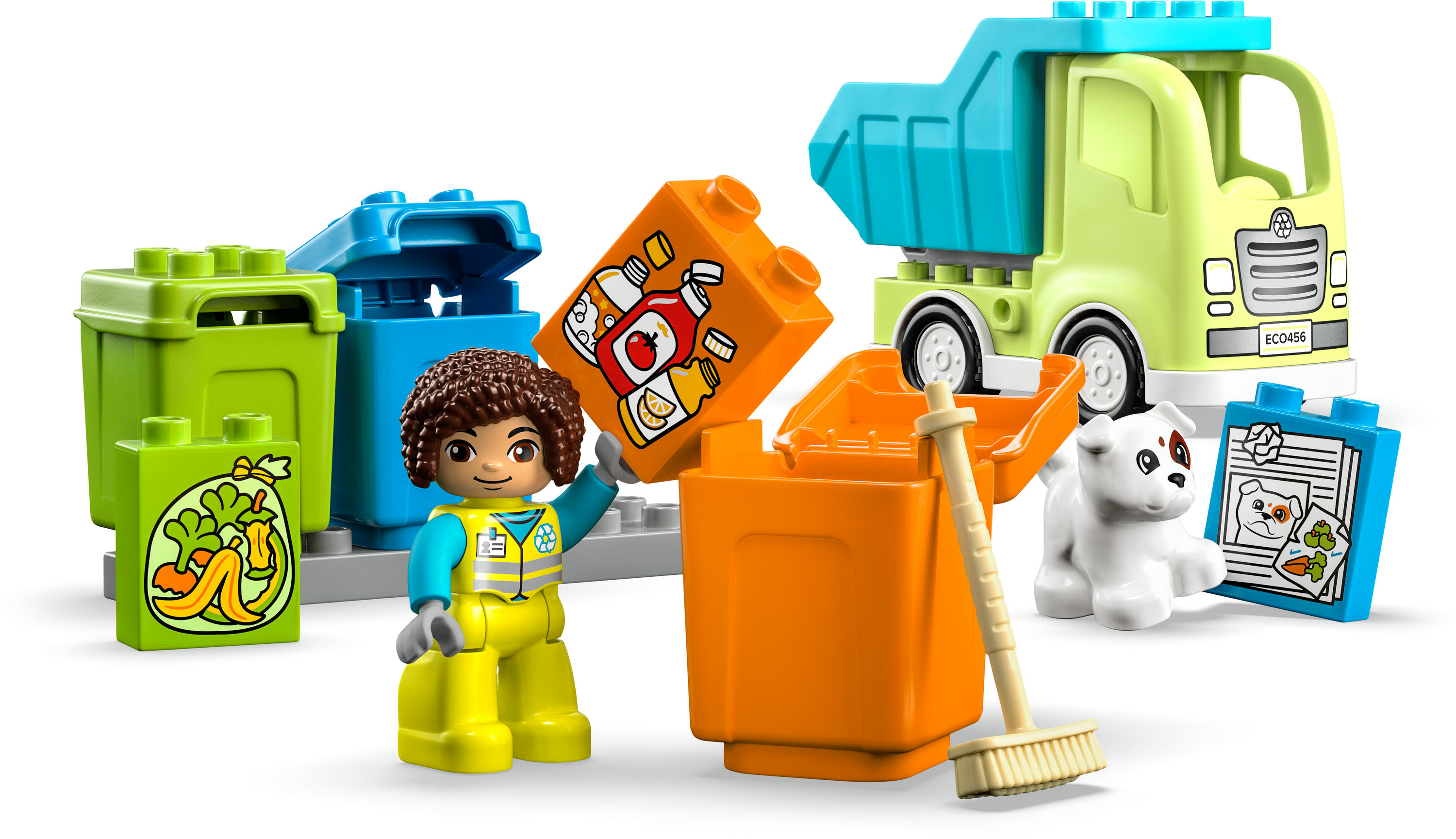 Eine Lego-Szene mit einem Lastwagen, Mülltonnen, einer Figur und einem Hund. Die Figur hält einen Behälter mit einem Essensbild.