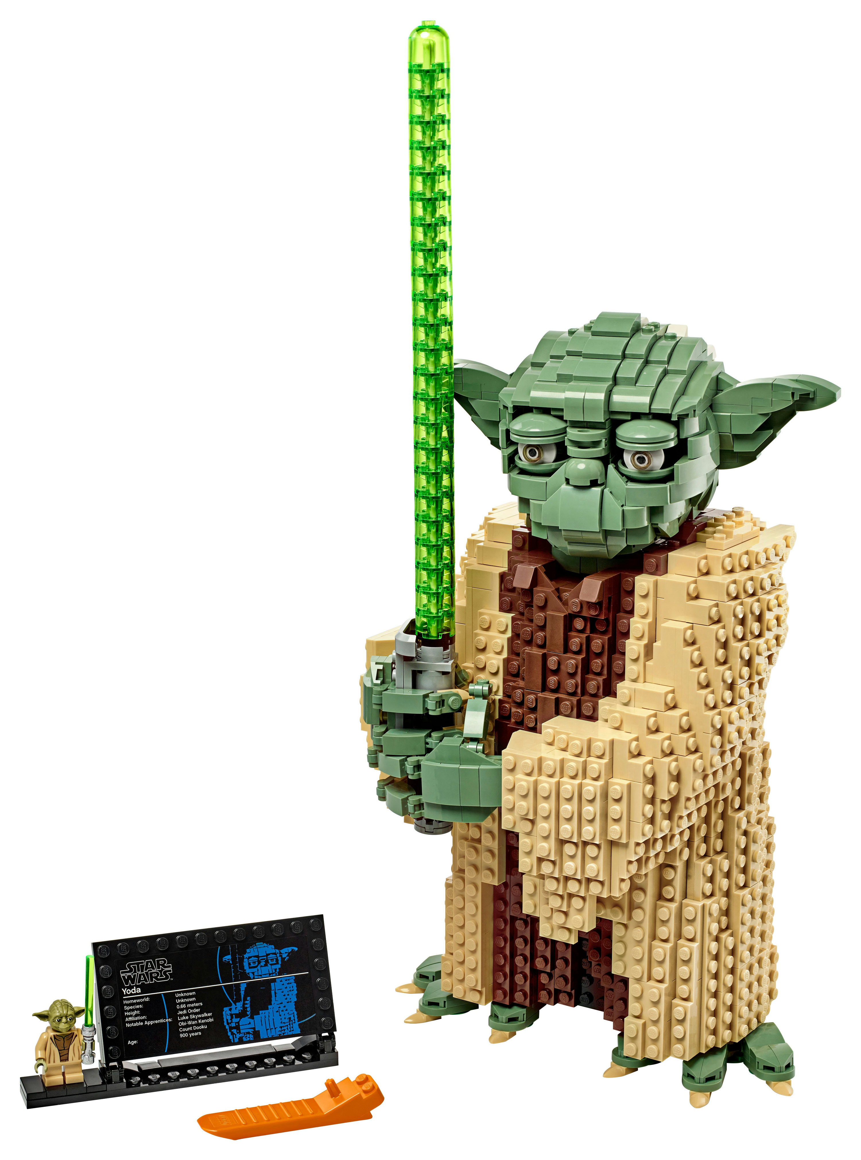 Lego Yoda figure holding a green lightsaber, standing with a display card.