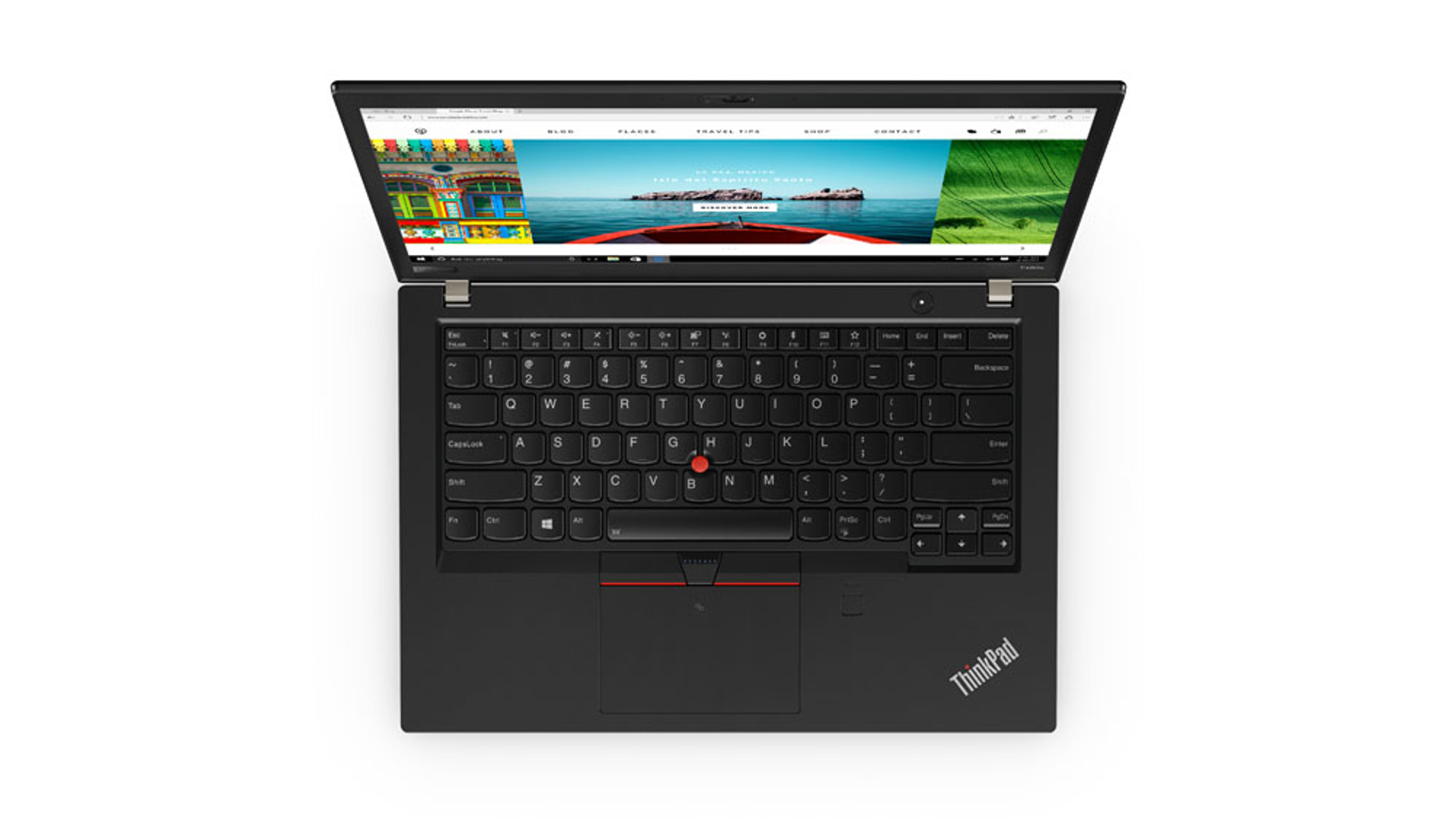 Portátil ThinkPad negro, abierto en superficie blanca, mostrando una página web.