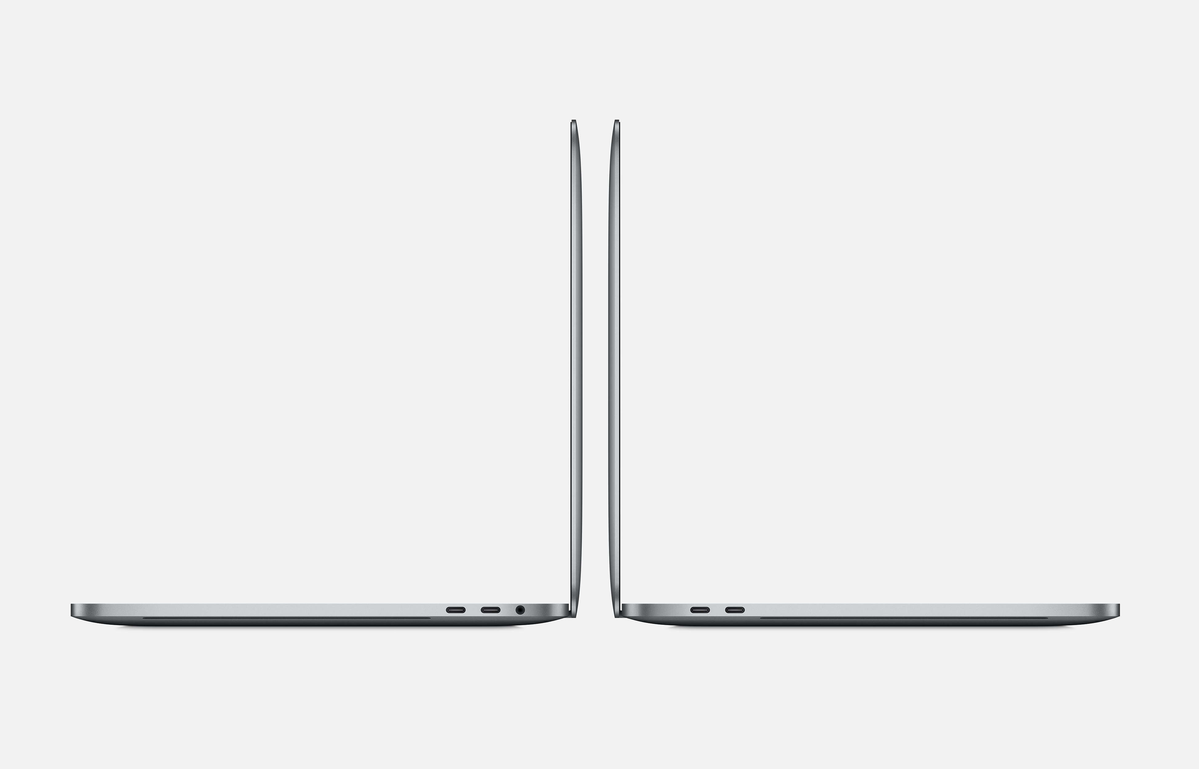 Due laptop grigi, viste laterali, uno di fronte all'altro. Lo sfondo è grigio chiaro.