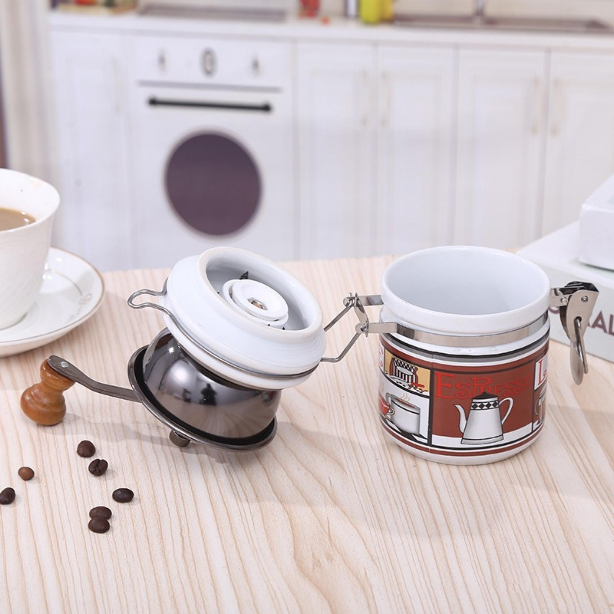 Ein Kaffeebehälter mit Mühle und Kaffeebohnen auf einem Holztisch.