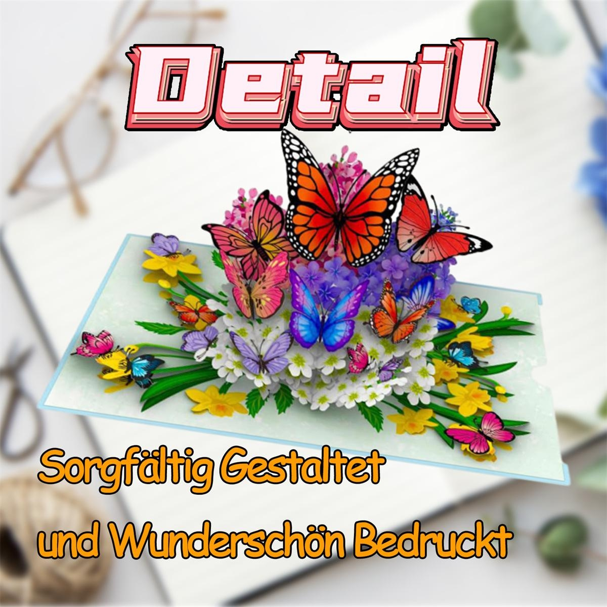 Eine Pop-up-Karte mit bunten Schmetterlingen und Blumen. Die Karte liegt auf einem Schreibtisch.