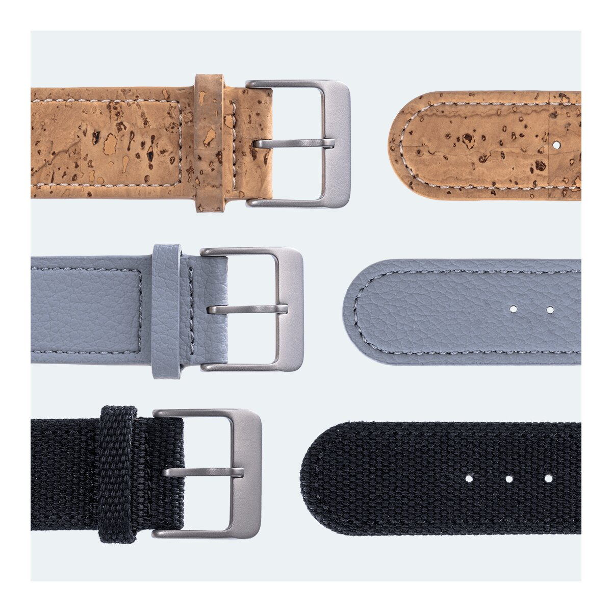Nahaufnahme von Uhrenarmbändern. Drei Paar Armbänder. Kork, graues Leder und schwarzer Stoff. Metallschnallen sichtbar.