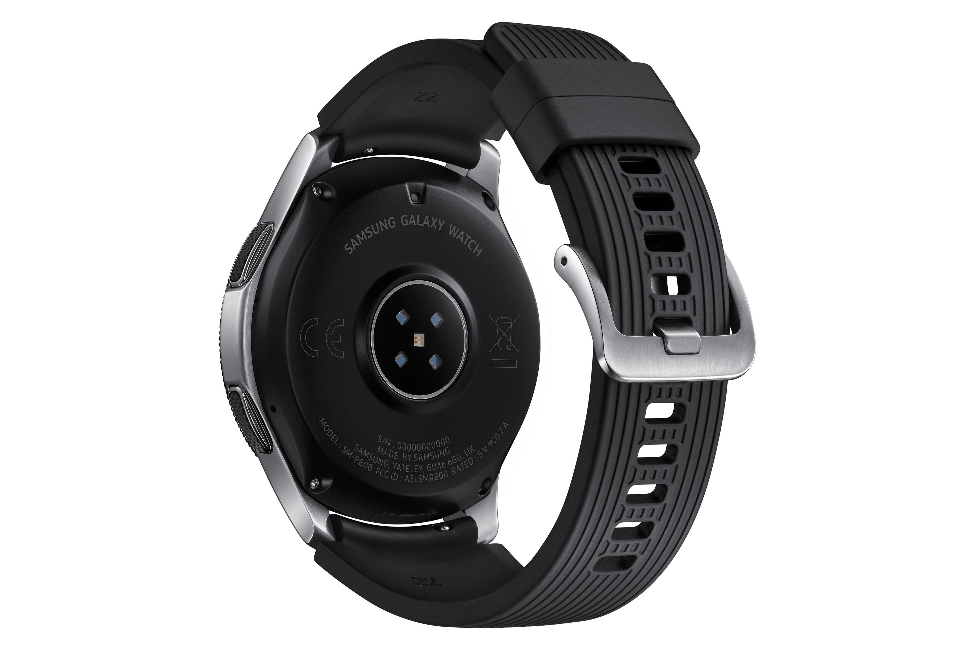 Schwarze Samsung Galaxy Watch, Rückansicht. Mit Sensoren, Etiketten und schwarzem Armband.