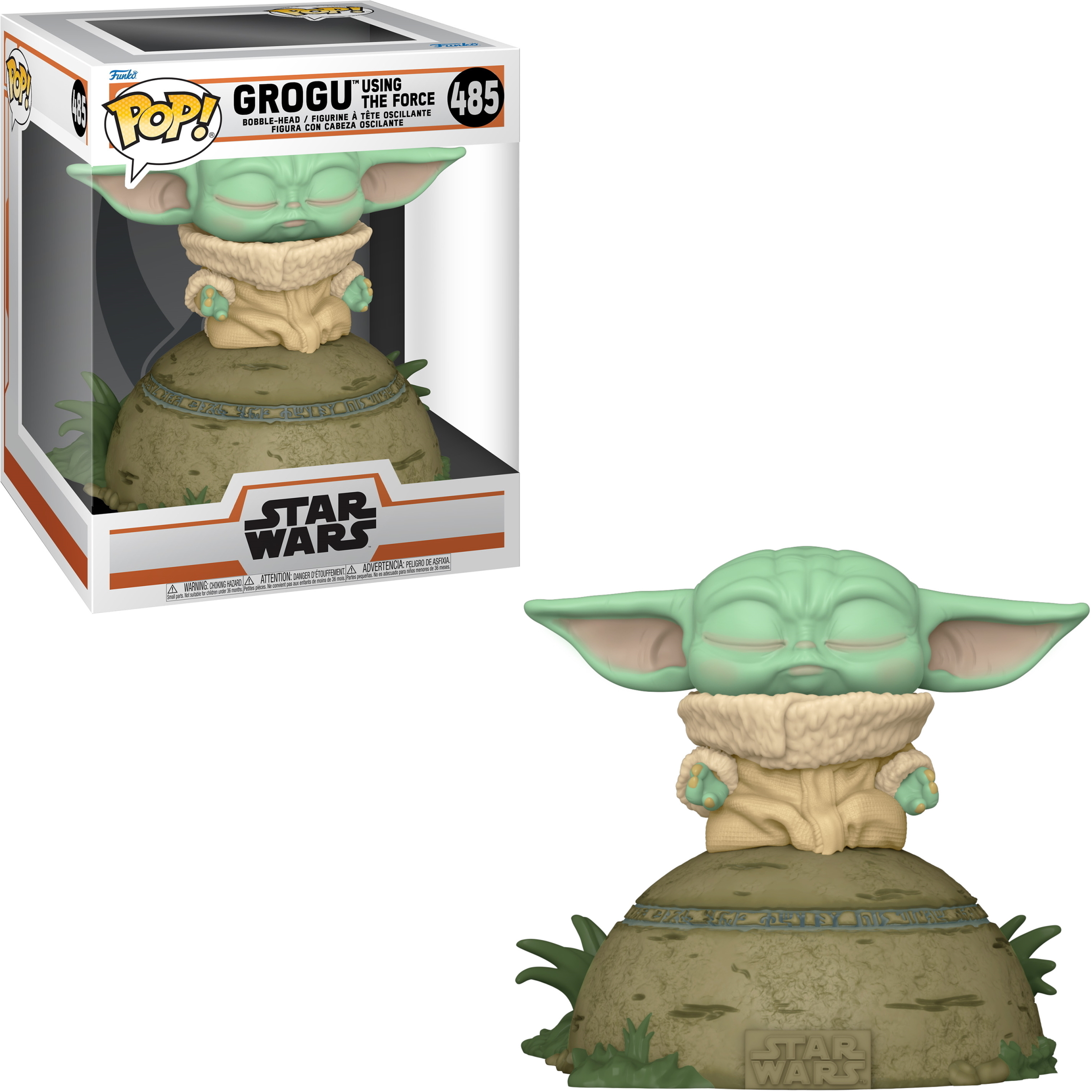 Una figura di Grogu (Baby Yoda) da Star Wars, in una scatola e esposta su una base a forma di roccia.